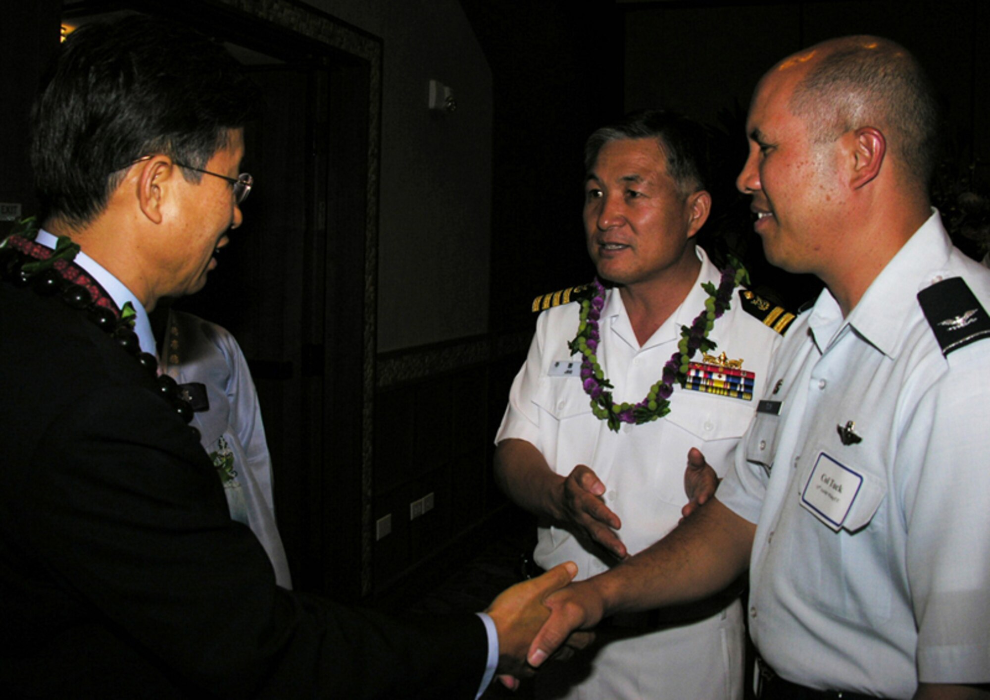 From left, Bong Joo Kim, Consul General of the Republic of Korea ( ROK),  Capt  Hyung Kyu Joo, ROK Defense Military Attache, and Col Giovanni Tuck, 15th Airlift Wing Commander shakes hands during a reception on Oct 3. (U.S. Air Force photo by Jackie Hites)