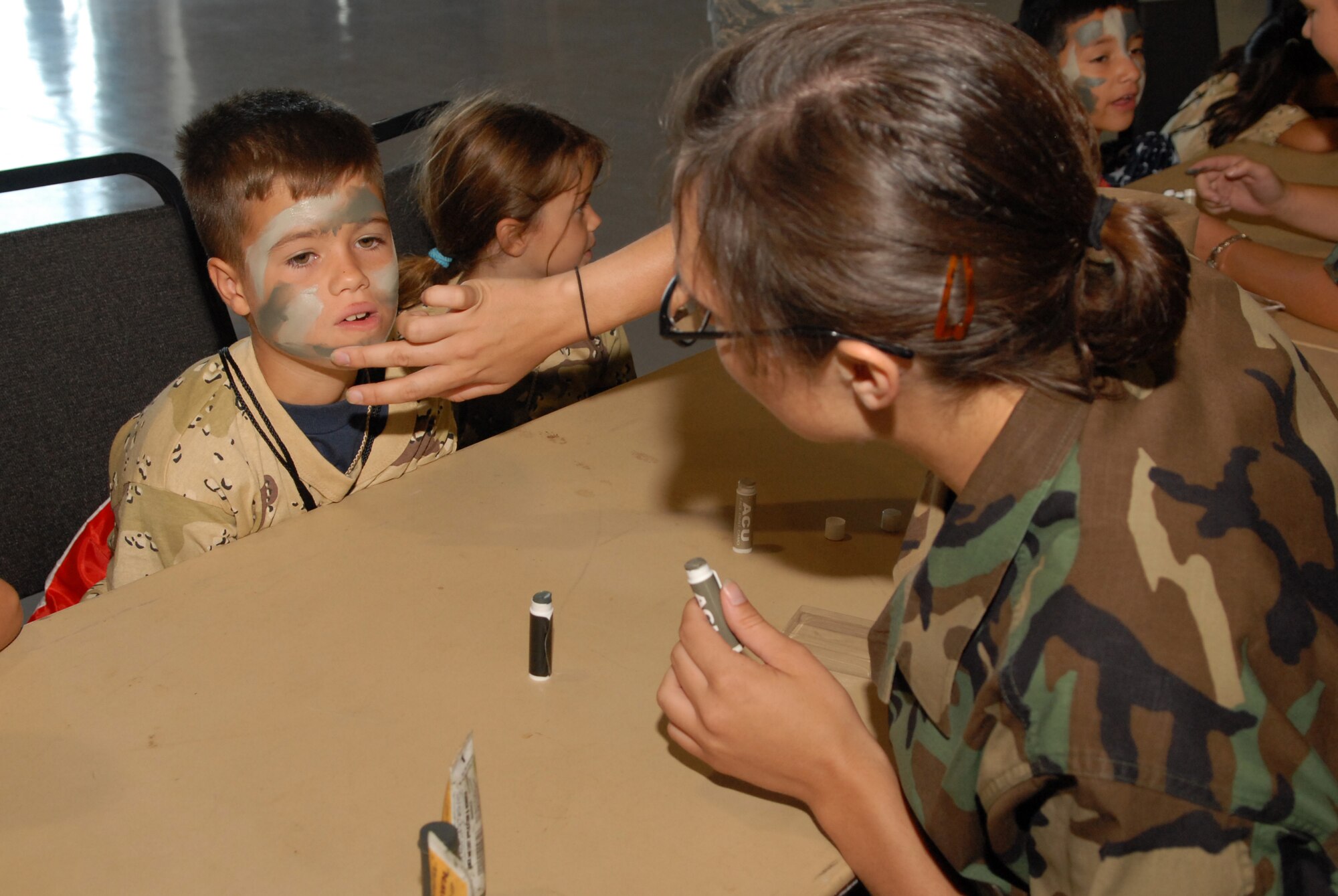 Preparing for battle with help from a volunteer Oct. 4 is Operation KIDS participant Anthony Desantis, son of Master Sgt. Thomas Desantis, 315th Training Squadron first sergeant. (U.S. Air Force photo by Senior Airman Kasabyan Musal)