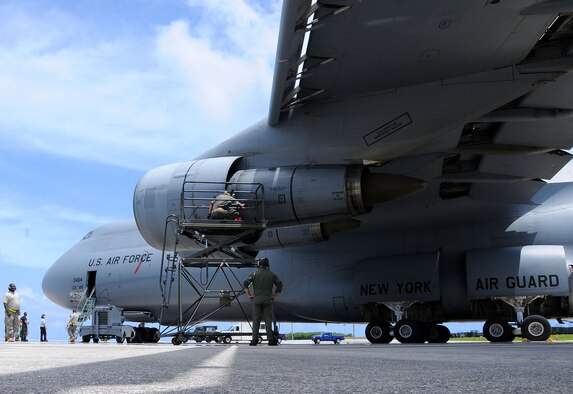 ANDERSEN AIR FORCE BASE, Guam - Airmen from the 734th Air Mobility Squadron, 36th Contingency Response Group, 44th Aerial Port and 105th Airlift Wing, Stewart Air National Guard, N.Y., prepare to unload equipment from a C-5 Galaxy here Sept. 25. The aircraft contained Navy personnel and equipment here to support Operation Enduring Freedom Philippines. 