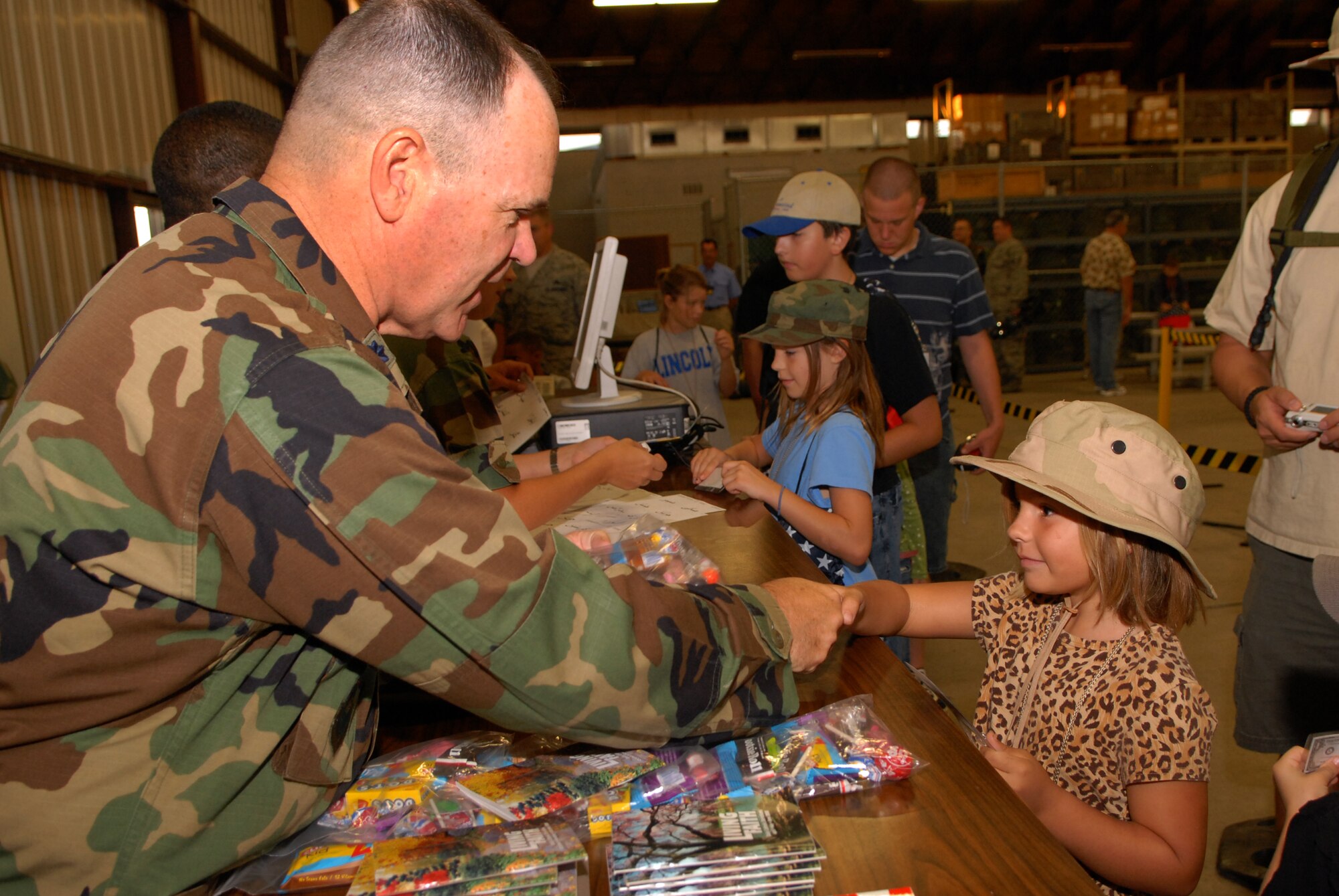 Chaplain (Lt. Col.) James Ludwikoski briefs Amy Mutka, daughter of Tech. Sgt. Steven Mutka, 17th Security Forces Squadron, during Operation KIDS Oct. 4. (U.S. Air Force photo by Senior Airman Kasabyan Musal)