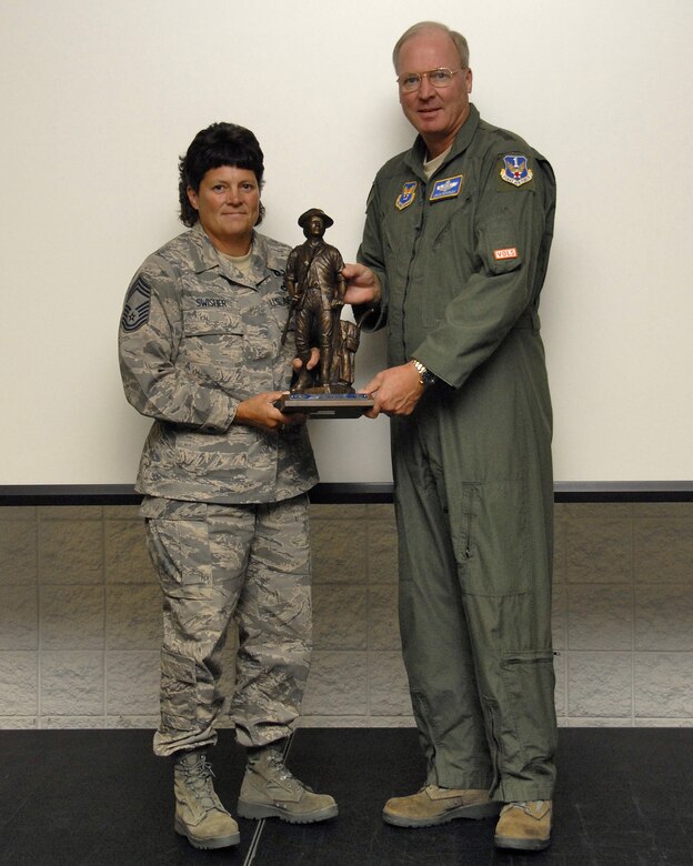 Chief Master Sgt Dena Swisher receives the ANG Outstanding Safety Achievement Award (AKA the Safety Heisman) from ANG Director Lt Gen Craig McKinley. 