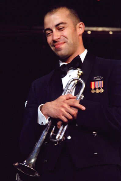 LAUGHLIN AIR FORCE BASE, Texas -- Senior Airman David Evans, Air Force Band of the West member and Del Rio native, takes a rest before continuing his solo performance on the trumpet while friends and family look on in admiration in the crowd at the Paul Poag Theatre October 2. (U.S. Air Force photo by Airman 1st Class Sara Csurilla)
