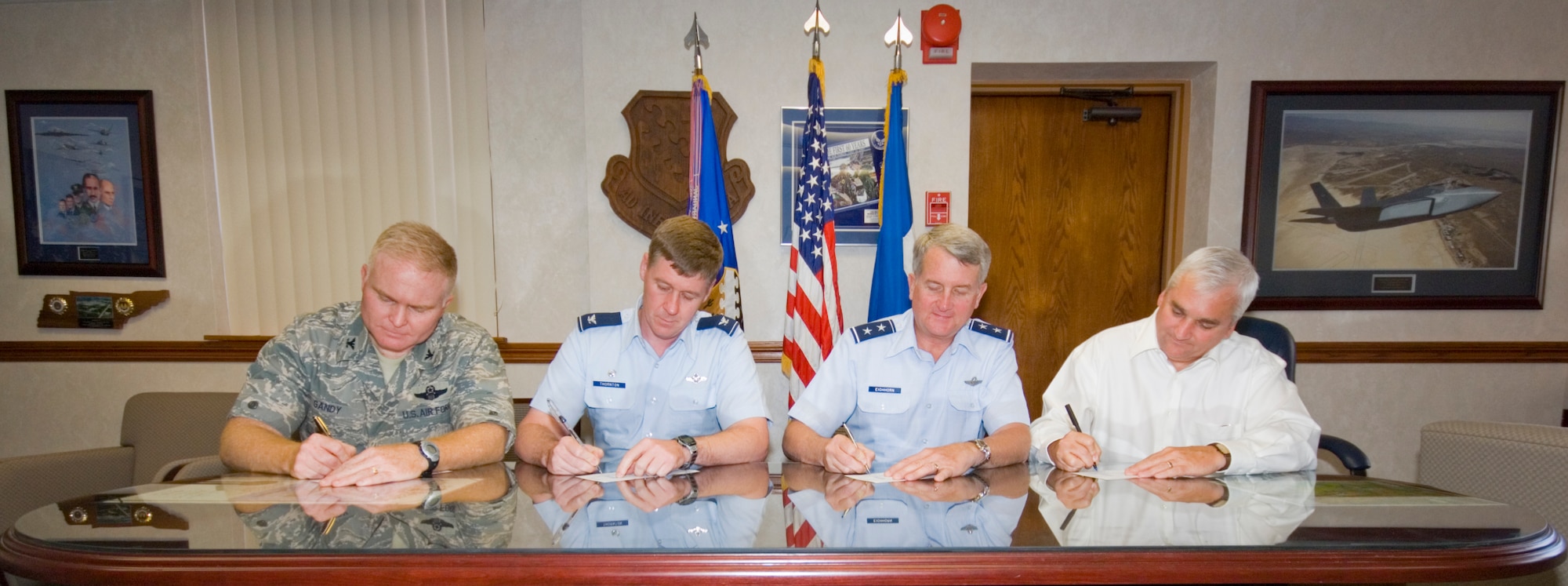 From left: Col. Jerry Gandy, 95th Air Base Wing commander; Col. William Thornton, 412th Test Wing commander; Maj. Gen. David Eichhorn, Air Force Flight Test Center commander; and Kevin Petersen, NASA Dryden Flight Research Center director, fill out Combined Federal Campaign donation forms at Building 1 on Oct. 6. The CFC is the only official federal employee charity solicitation event. (Air Force photo by Mike Cassidy)