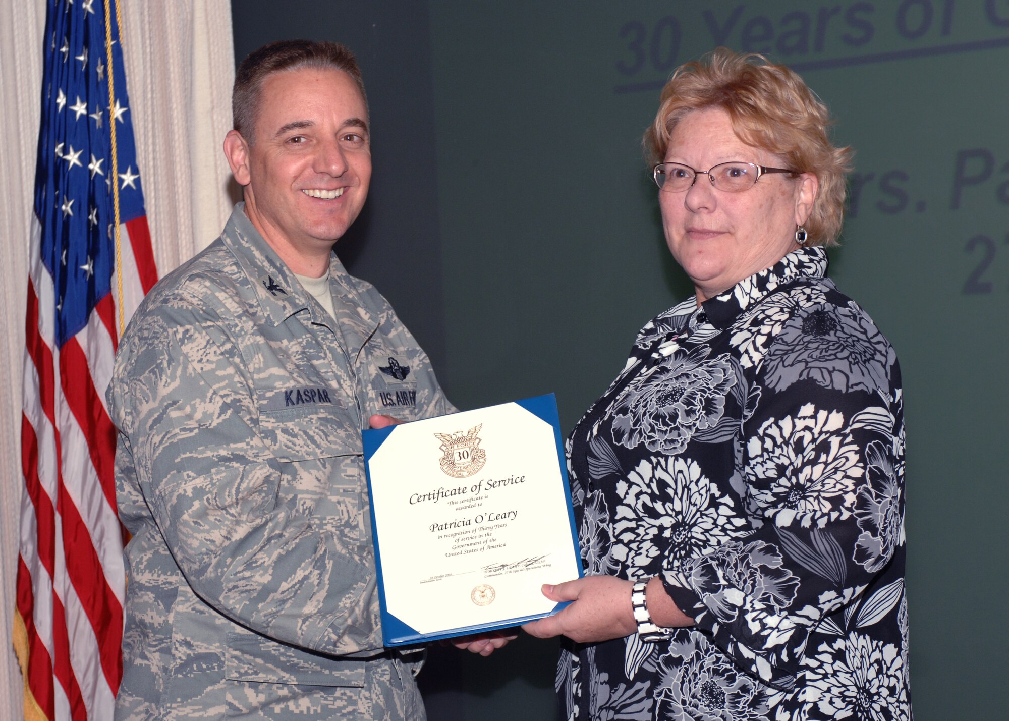 CANNON AIR FORCE BASE, N.M.- Col. Hans Kaspar, 27th Special Operations Wing vice commander, presents Patricia O'Leary, 27th Special Operations Maintenance Operations Squadron, a letter of appreciaton and a pin Oct. 7 for her service at Cannon.  Ms. O'Leary has worked with the Air Force for more than 30 years.  (U.S. Air Force photo by Airman 1st Class James R. Bell)