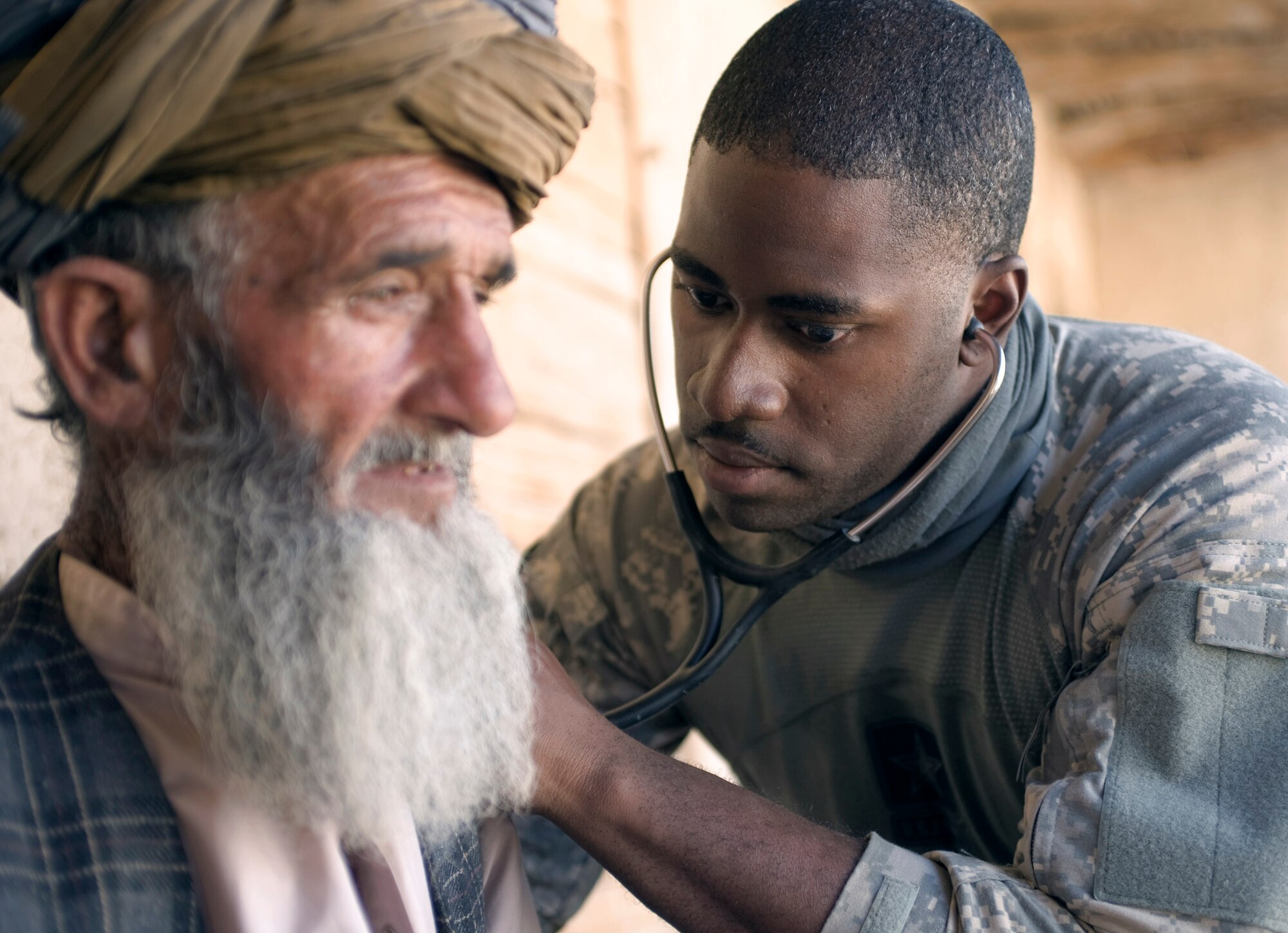 Senior Airman Courtney Thompson examines an Afhgan man at a village medical outreach clinic in the small, mountainous village of Pacha Hawk, Afghanistan. The event, two months in the making, brought a 40-person, joint-service team to the remote, mountain-top village. Airman Thompson is Kapisa and Parwan Provincial Reconstruction Team medic. (U.S. Air Force photo/Master Sgt. Keith Brown) 
