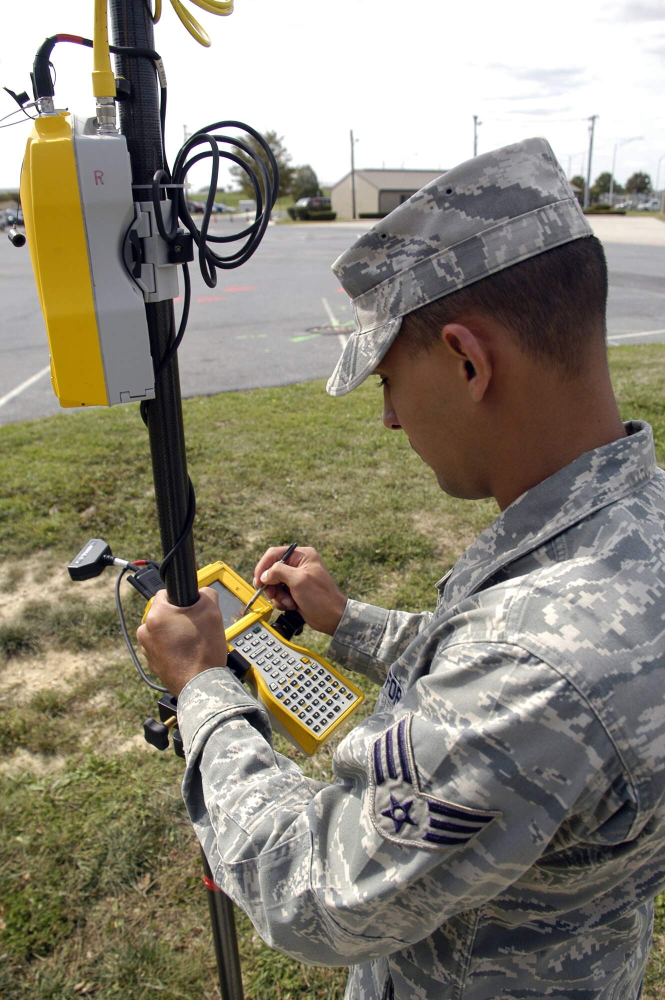 Senior Airman Yuslain Perez, 436th Civil Engineer Squadron, uses a Global Navigation Satellite System to survey the exact measurements of the hospital parking lot.  This survey must be done to let the construction crew know where to build the new parking lot, which will provide increased parking capacity. The project is estimated to be completed in the early spring of 2009. (U.S. Air Force photo/ Airman 1st Class Shen-Chia Chu)