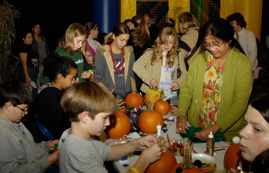HANSCOM AFB, Mass. – The 66th Services Squadron hosted Oktoberfest at the Tennis Bubble on Oct. 3, shown here children decorate pumpkins in one of the many family activities offered at the event. (U.S. Air Force photo by Linda LaBonte Britt)