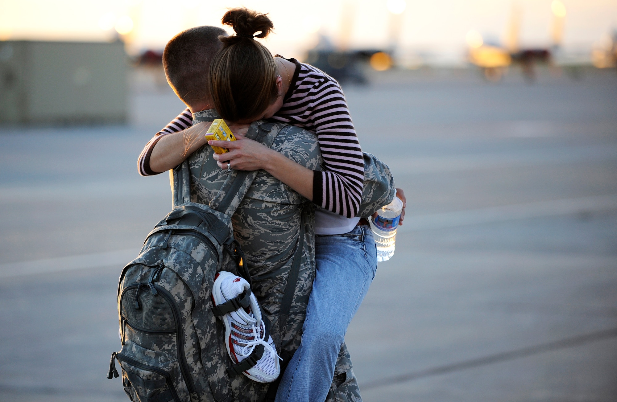 MOUNTAIN HOME AIR FORCE BASE, Idaho -- Senior Airman Benjamin Harvell, 389th Aircraft Maintenance Unit, embraces his wife Oct. 6 after he returned from a  four-month deployment to Andersen AFB, Guam. More than 400 389th Aircraft Maintenance Unit personnel supported the flying mission of 18 F-15E Strike Eagles deployed to Guam to provide flexible air-to-air and air-to-ground attack capabilities over the Pacific. (U.S. Air Force photo by Airman 1st Class Ryan Crane)