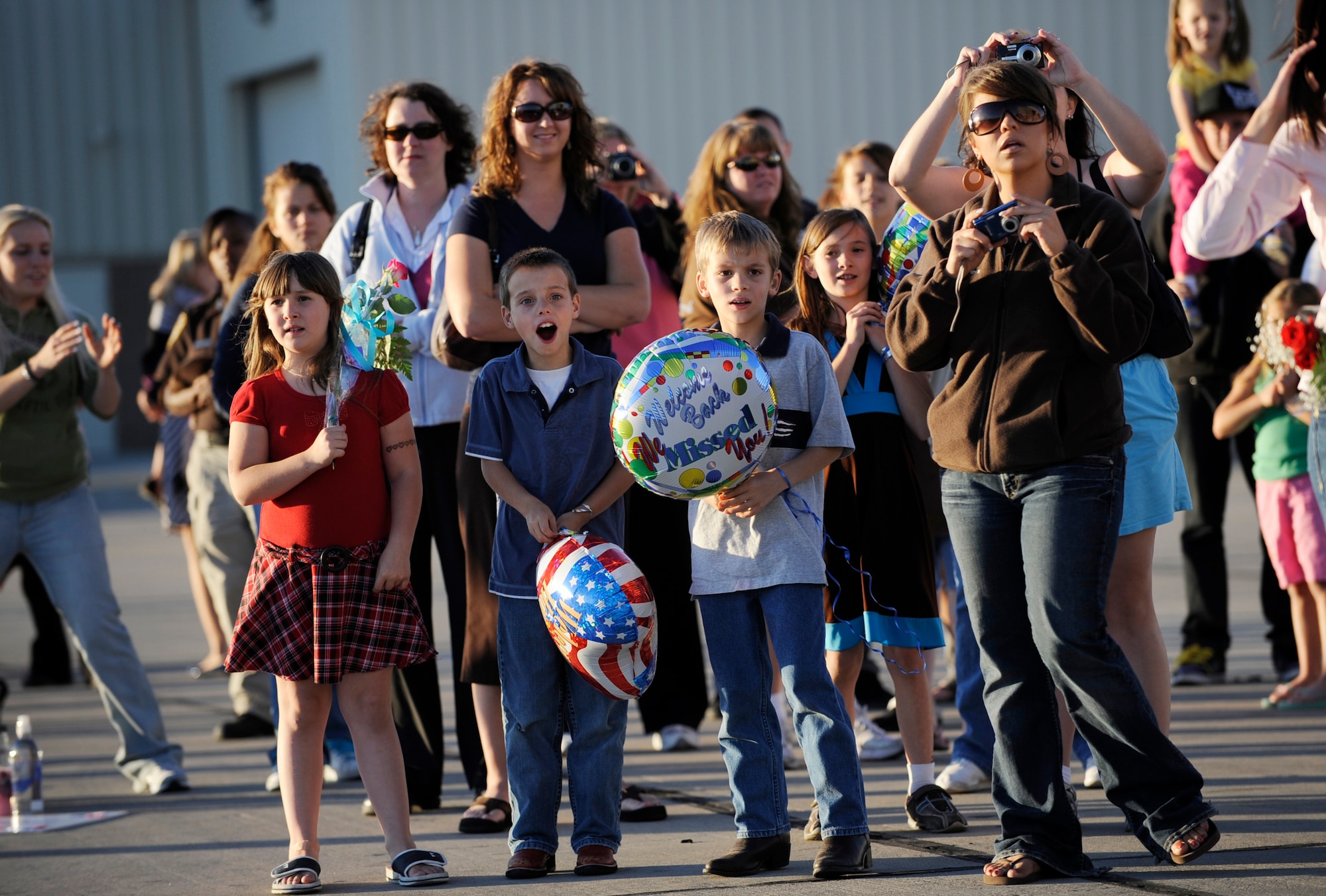 MOUNTAIN HOME AIR FORCE BASE, Idaho -- Families of military members from the 389th Aircraft Maintenance Unit wait as more than a 100 members fly into Mountain Home Oct. 6 after a four-month deployment to Andersen AFB, Guam. The 389th AMU supported the flying mission of 18 F-15E Strike Eagles deployed to Guam to provide flexible air-to-air and air-to-ground attack capabilities over the Pacific. (U.S. Air Force photo by Airman 1st Class Ryan Crane)