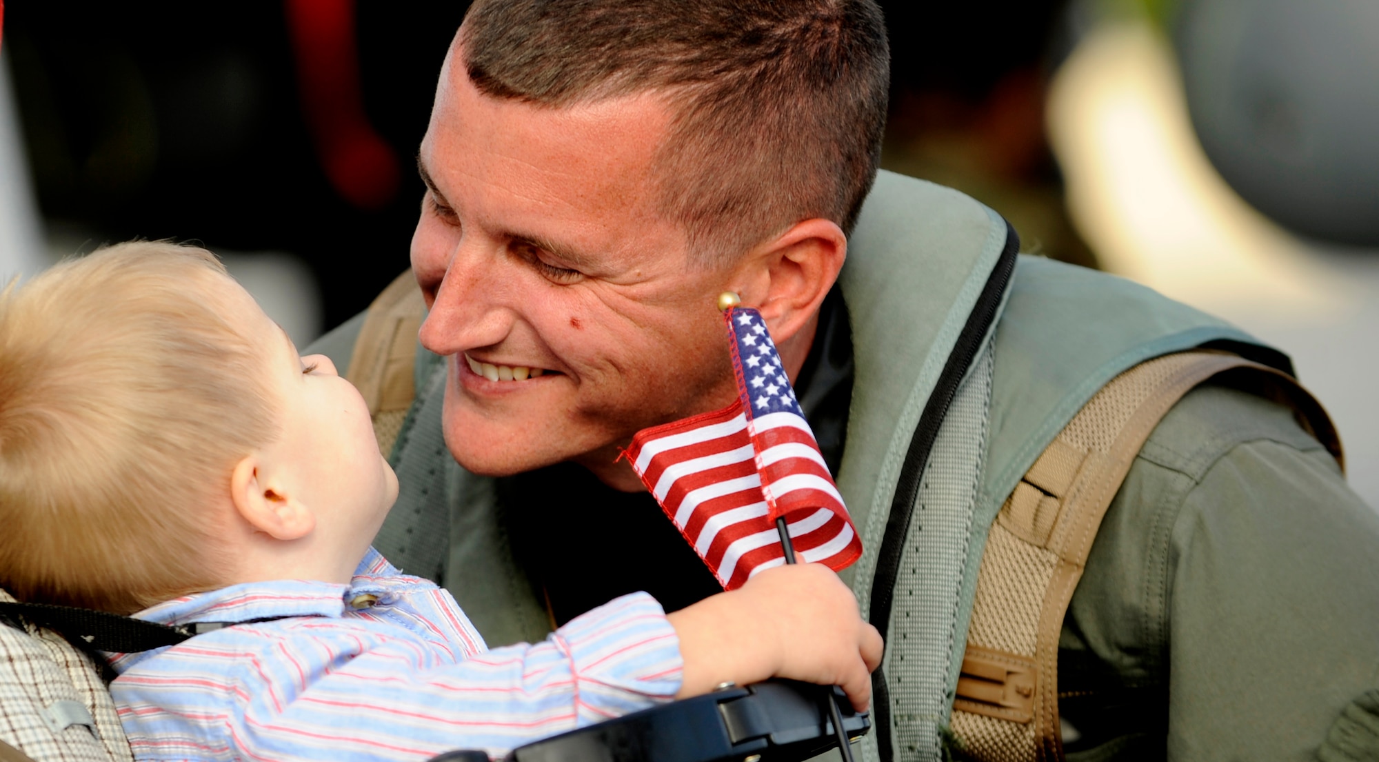 MOUNTAIN HOME AIR FORCE BASE, Idaho -- Capt. Ian Cunningham, 389th F-15E Strike Eagle pilot shares a moment with his son after landing at the base, Oct. 6. Members of the 389th Thunderbolts returned from a four-month long deployment to Andersen AFB, Guam where they provided flexible air-to-air and air-to-ground attack capabilities over the Pacific. (U.S. Air Force Photo/ Airman 1st Class Stephany Miller)