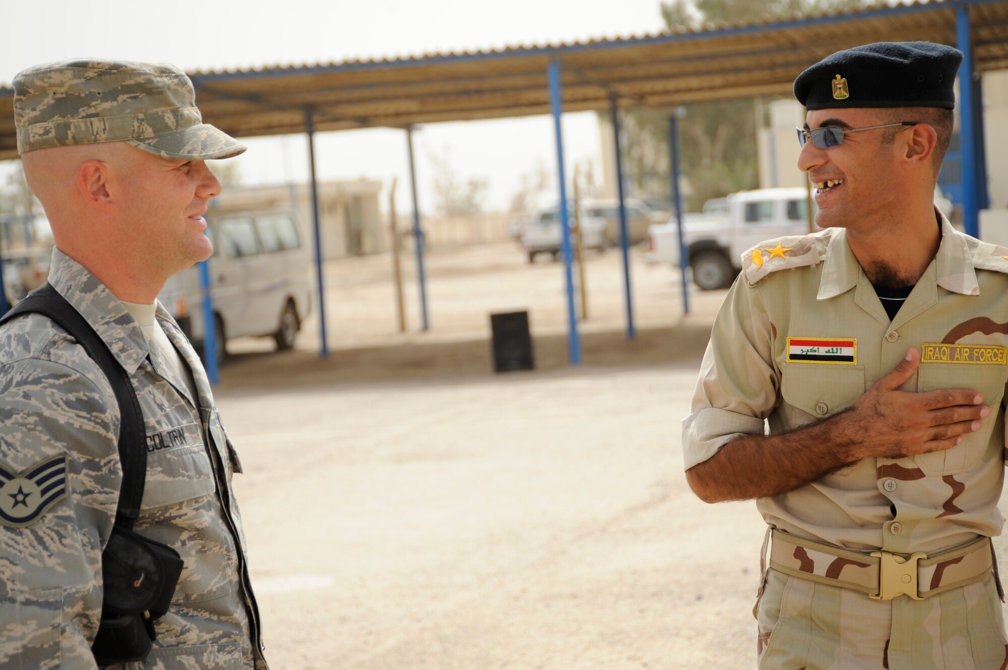 AL TAJI AIR BASE, Iraq -- U.S. Air Force Staff Sgt. Matthew Coltrin, left, a military training instructor air advisor with the 370th Expeditionary Training Squadron, talks about the training day with Iraqi air force Lt. Layth, a military training instructor, at Al Taji Air Base, Iraq on Sept. 28. Coltrin, a Lake Charles, La. native, advises the Iraqi MTI's on how to conduct physical training, dorm set up, drill, and lectures. (U.S. Air Force photo/Staff Sgt. Paul Villanueva II)