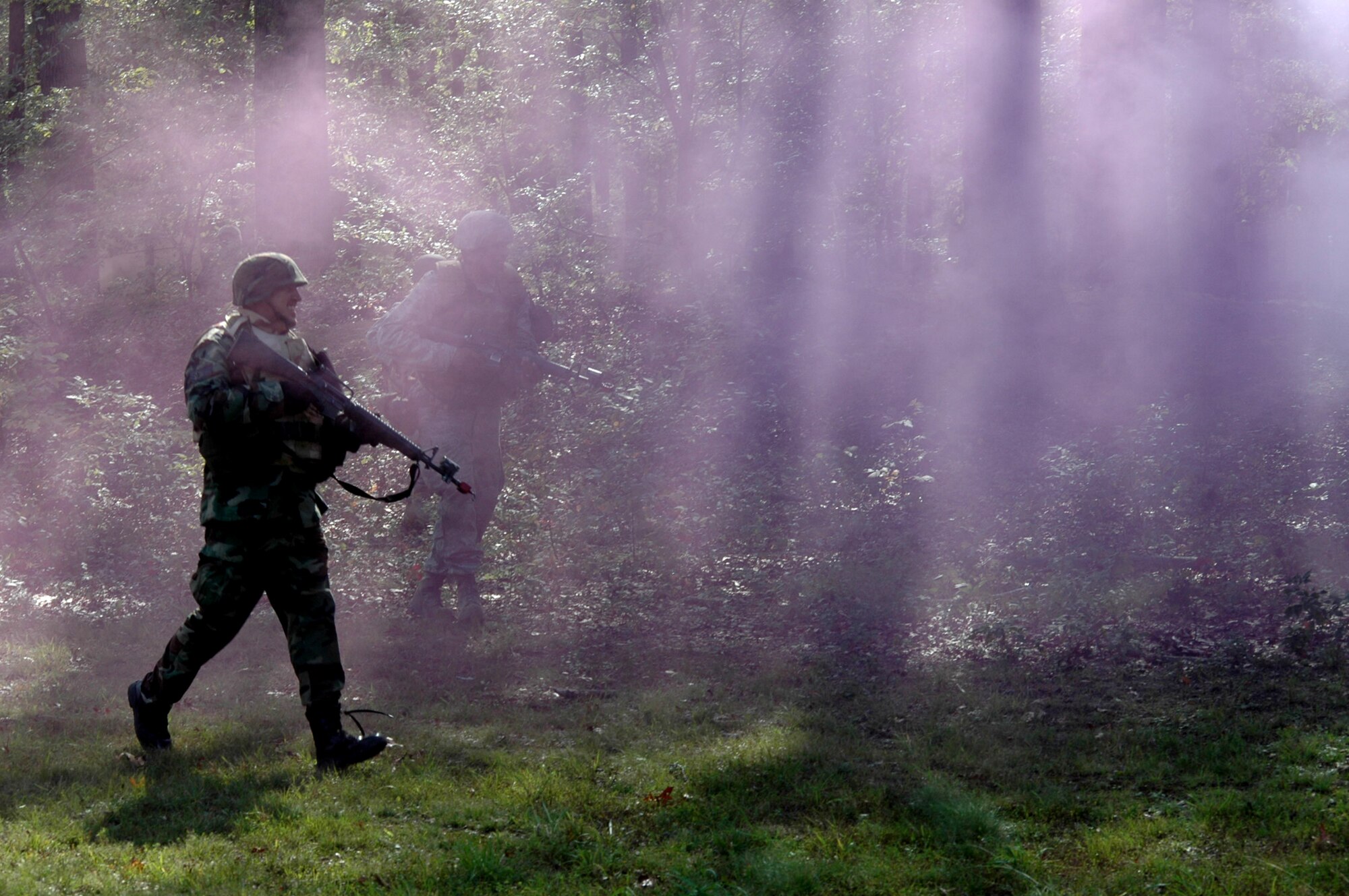 Students from the Advanced Contingency Skills Training Course 09-1 run through a purple haze to attack the enemy during a training scenario on a Fort Dix, N.J., range Oct. 4, 2008. A CST is taught by the U.S. Air Force Expeditionary Center's 421st Combat Training Squadron at Fort Dix and in fiscal 2008 prepared more than 1,500 Airmen for deployments. (U.S. Air Force Photo/Staff Sgt. Paul R. Evans)