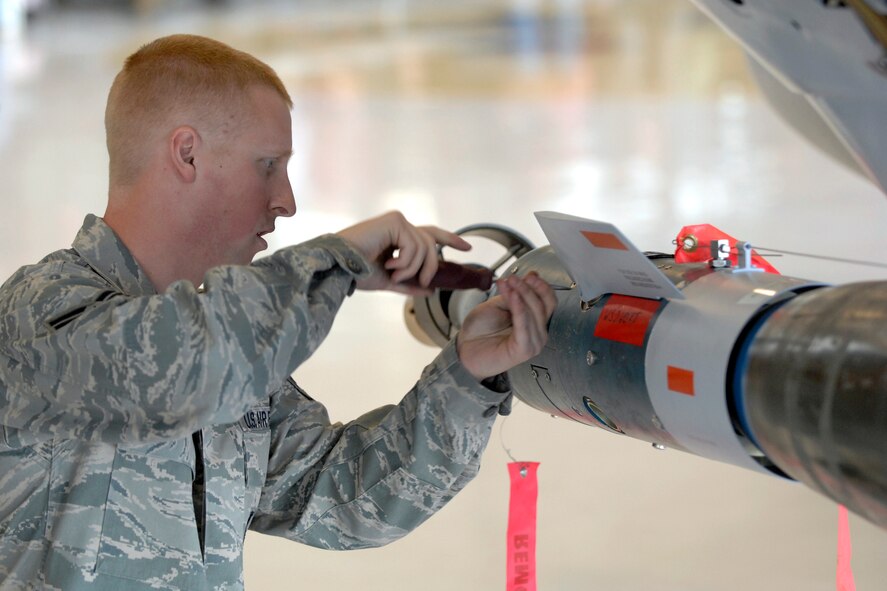 Airman 1st Class Daniel Retting of the 421st Aircraft Maintenance Unit installs fins on a GBU-12 during the Load Crew of the Year competition here Sep. 19. Annual awards for 388th MXG Airmen, including the winners of this load crew competition, were presented at the Maintenance Professional of the Year banquet at the Davis Conference Center Oct. 4. (U.S. Air Force photo by Todd Cromar)