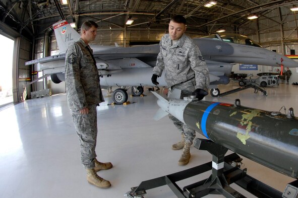 Master Sgt. Larry Driver (left), 388th Maintenance Group load standardization team chief, and Staff Sgt. Heath Neighoff, 421st Aircraft Maintenance Unit, prepare a GBU-38 for the Load Crew of the Year competition here Sep. 19. Annual awards for 388th MXG Airmen, including the winners of this load crew competition, were presented at the Maintenance Professional of the Year banquet at the Davis Conference Center Oct. 4. (U.S. Air Force photo by Todd Cromar)