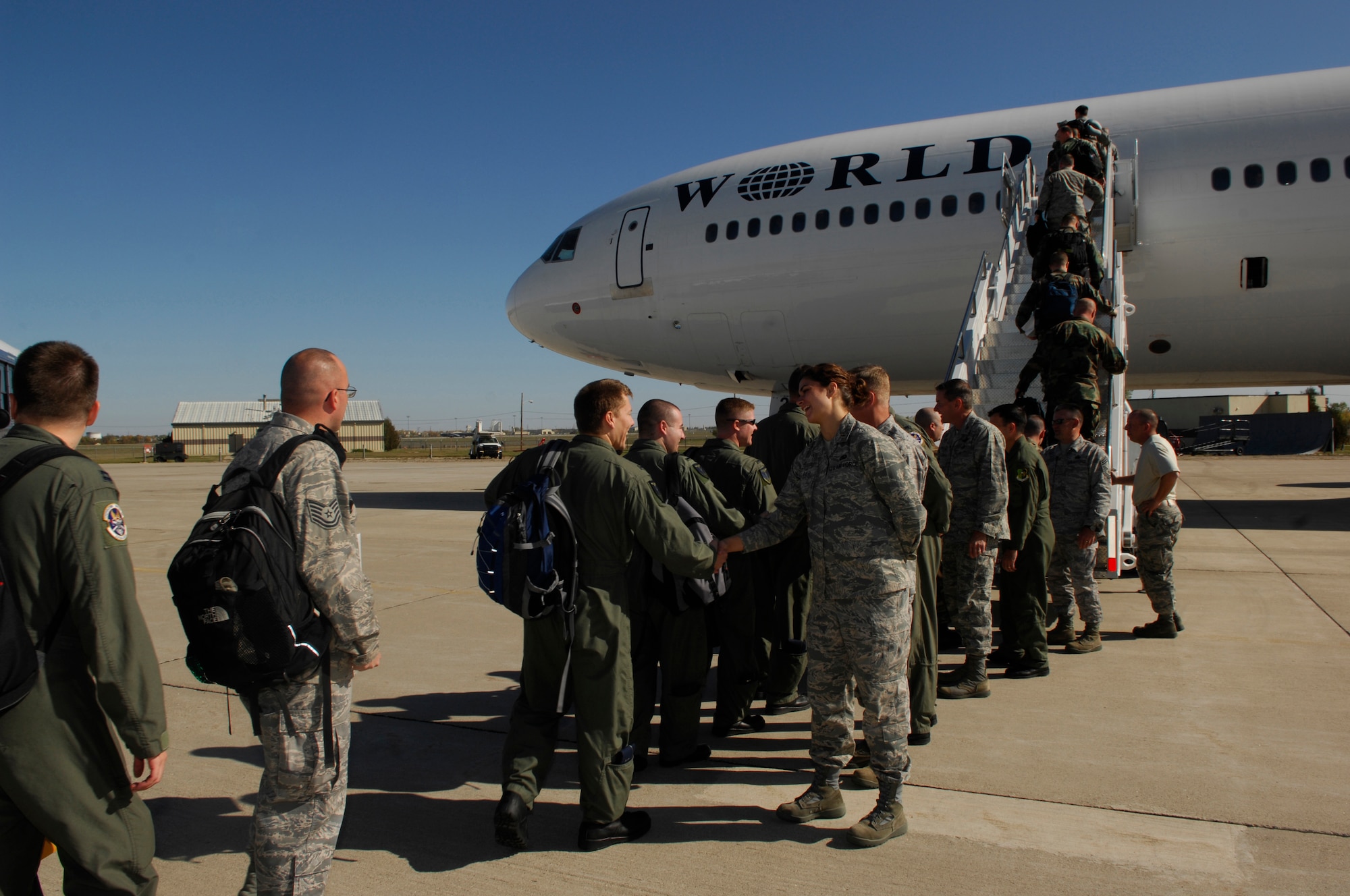 MINOT AIR FORCE BASE, N.D. – Airmen board the aircraft taking them to Andersen AFB, Guam here Oct. 2. The almost 300 Airmen are part of a four-month deployment rotation which will provide U.S. Pacific Command with a continuous bomber presence in the Asia-Pacific region. (U.S. Air Force photo by Senior Airman Joe Rivera)