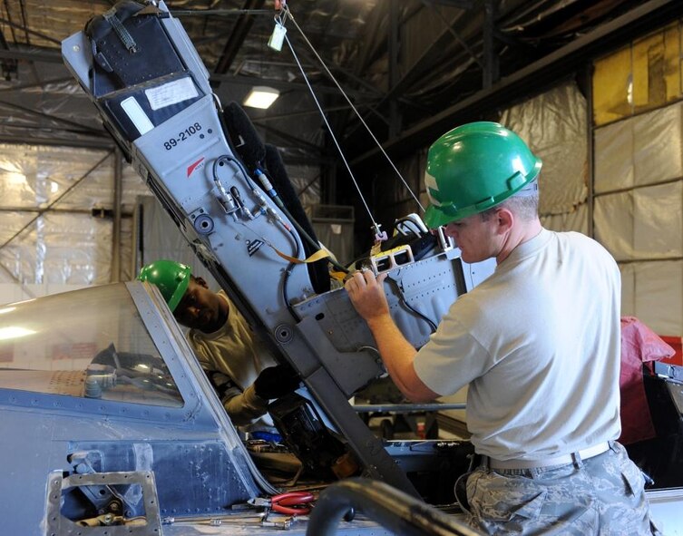 Staff Sgts. Michael Thibodeaux (left) and Timothy Conner (right) of the 388th Component Maintenance Squadron replace an F-16 ejection seat here Oct. 7. Top maintainers in the 388th Maintenance Group were recognized Oct. 4 at the annual Maintenance Professional of the Year banquet. (U.S. Air Force photo by Alex Lloyd)  