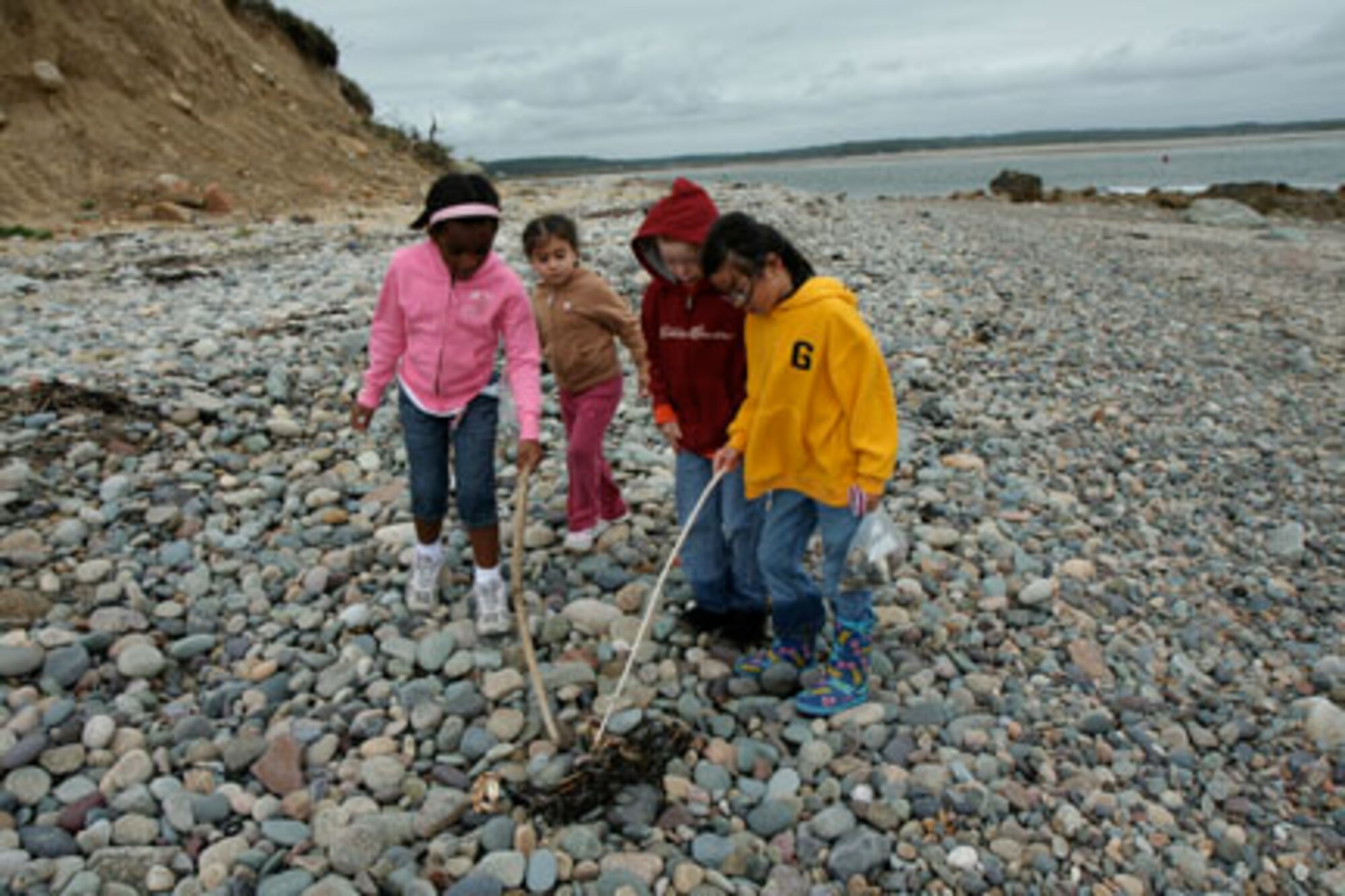 HANSCOM AFB, Mass. – Hanscom Primary School first grade students, from left, Kayleigh Daniel, Rebekah Murray, Nathan Hamill, and Juliette Gordon explore the shoreline at Fourth Cliff Recreation area in Humarock, Mass., during a recent field trip. The trip was part of a first grade science unit on habitats. (U.S. Air Force photo by Lt. Col. Loralee Manas)