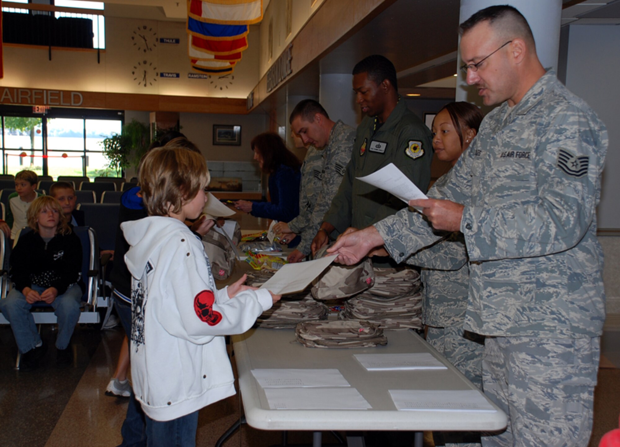 Sixth graders from North Hanover Township Upper Elementary School receive their orders and deployment bags in the Kids Deployment Line Oct. 3 in the Passenger Terminal. Children received everything they needed, including candy in place of immunizations, before their “deployment” to Camp Camel, Saudi Arabia. (U.S. Air Force photo/Airman 1st Class Bekah Phy)