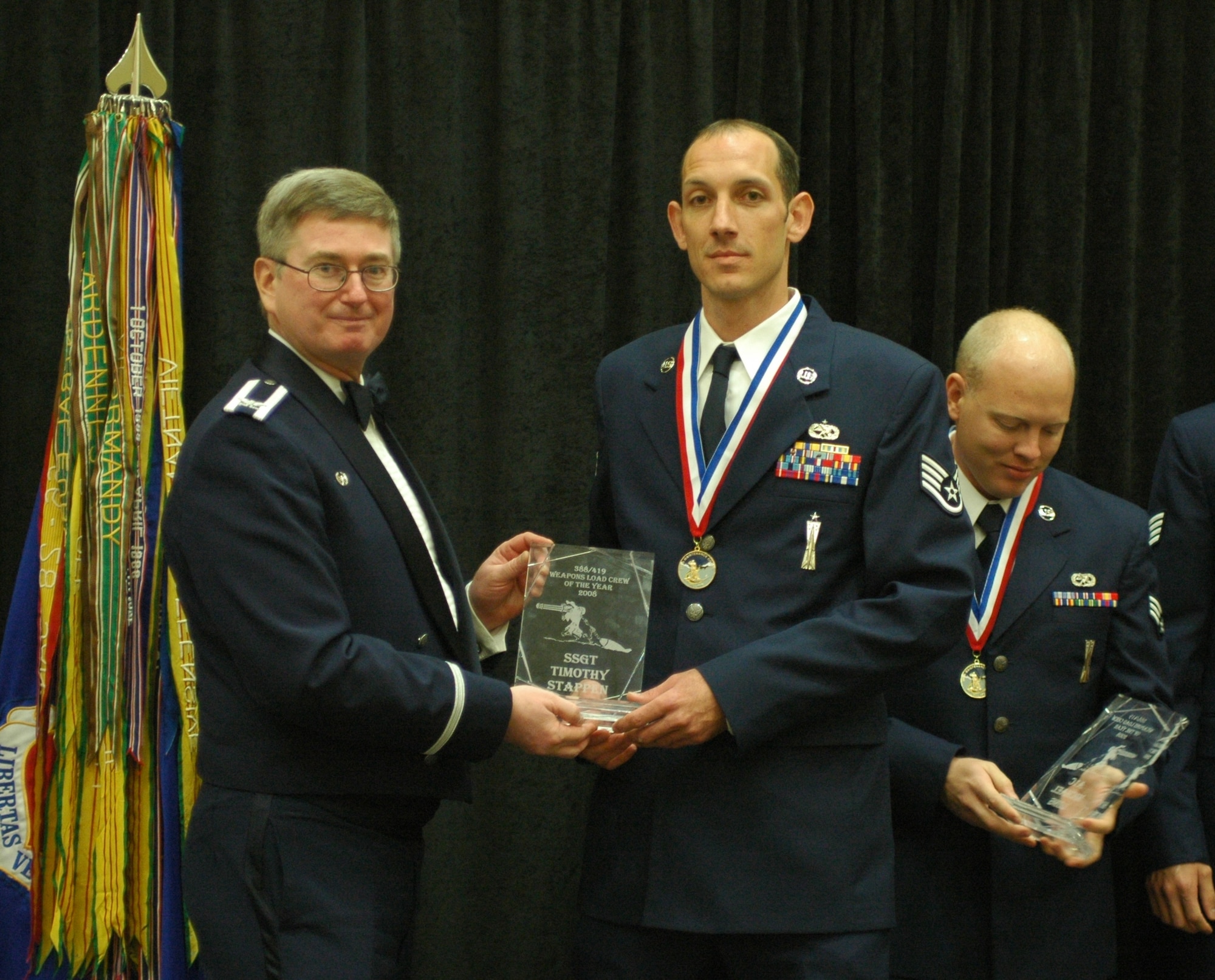 Staff Sgt. Timothy Stappen (right) of the 34th Aircraft Maintenance Unit is recognized by Col. Roger Rostvold, 388th Maintenance Group commander, at the Maintenance Professional of the Year banquet Oct. 4. Sergeant Stappen, Staff Sgt. Ronald Thomas and Airman 1st Class Michael Long made up the winning team in the Load Crew of the Year competition held Sep. 19. (Photo by Master Sgt. Ted Robinson)  