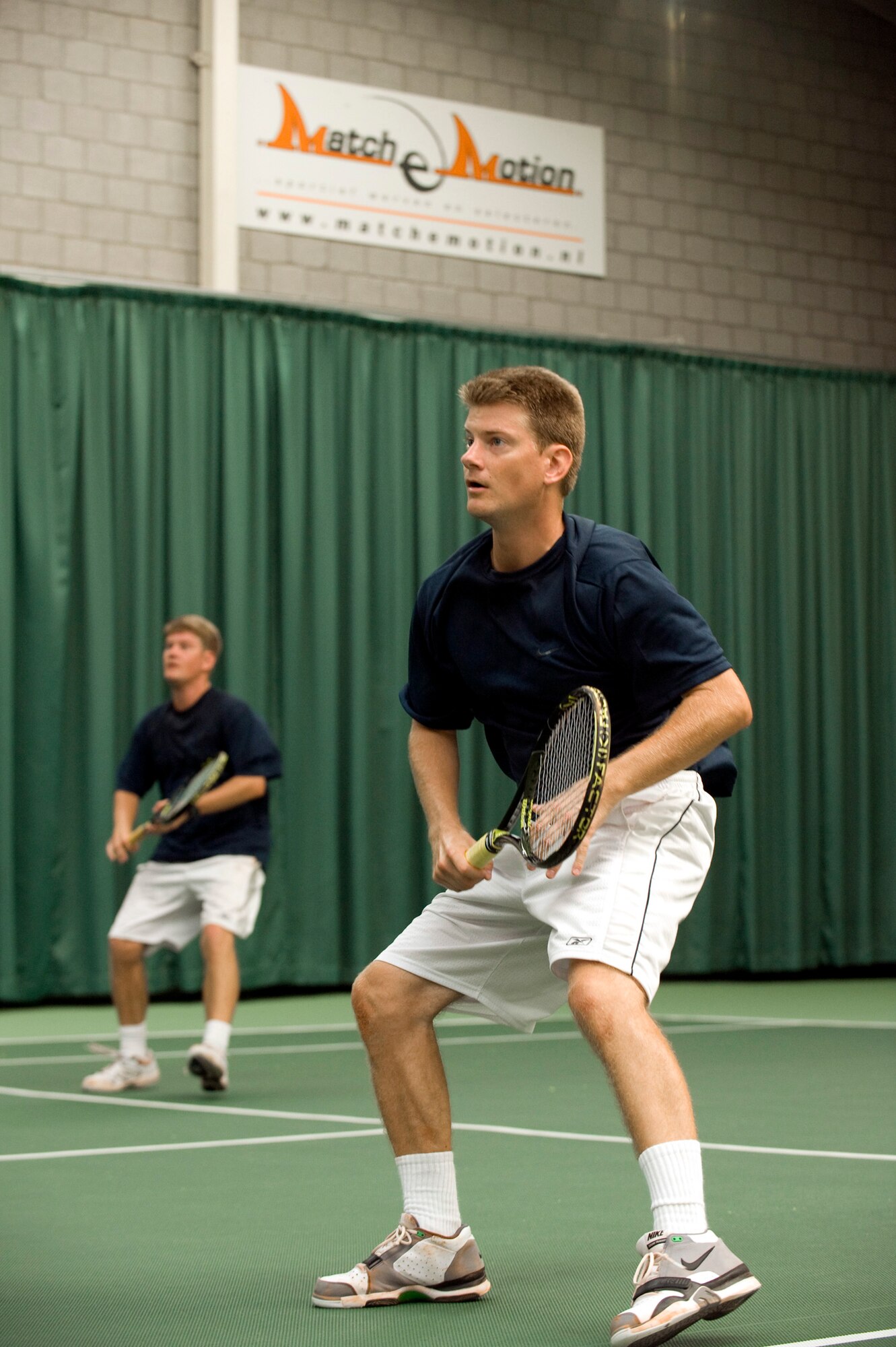 Front, Capt. Greg Zielinski, 6th Airlift Squadron C-17 pilot, and his twin brother Capt. Chris Zielinski, 6th AS C-17 pilot, go up against Poland in the last match of the CC Air Headquarters Ramstein Air Force International Tennis Tournament in Amsterdam Sept. 9-12. The event included six Air Force tennis teams selected from the U.S., Belgium, Poland, Germany, the United Kingdom and the Netherlands. The twin brothers posted a 4-0 record as the doubles team, helping Team USA earn first place at the event. (U.S. Air Force courtesy photo)