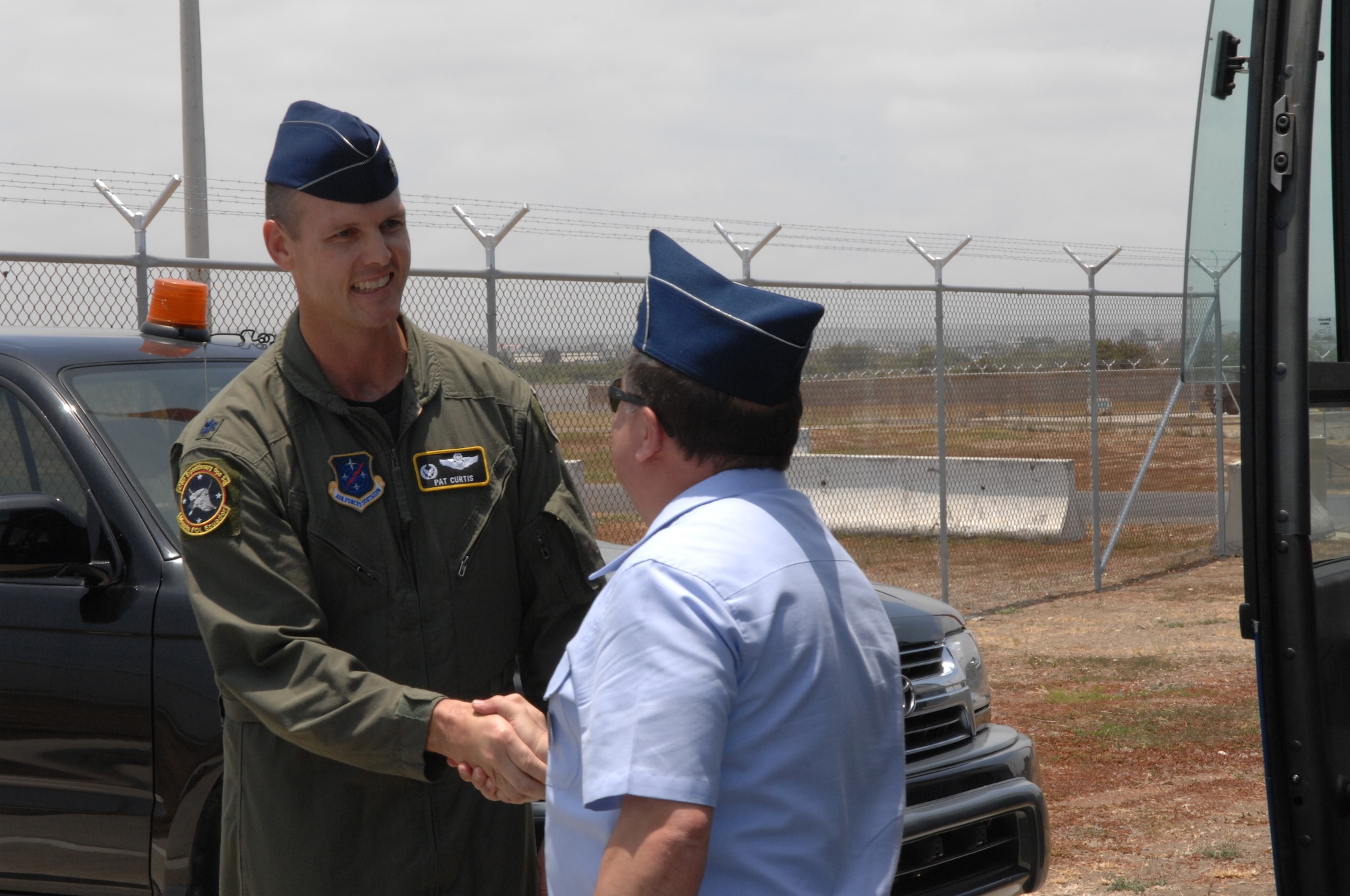 Lt. Col. Jared Patrick Curtis, 478th Expeditionary Operations Squadron commander, welcomes one of 20 attachés and instructors who visited here October 3. The servicemembers, representing approximately 10 nations throughout the world, toured the operations area here and received a unit mission brief. (US Air Force photo/1Lt. Lauren Wright)