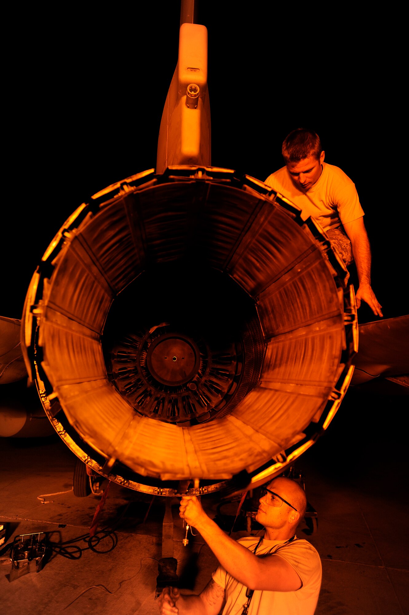 Staff Sgt. Danny Shaw (top) actuates an exhaust nozzle while Staff Sgt. Nathan Gadbois installs safety wiring around bolts on an F-16 Fighting Falcon Oct. 6, at Joint Base Balad, Iraq. Installing safety wire prevents parts from vibrating off the aircraft. Both Airmen are aerospace propulsion journeymen with the 332nd Expeditionary Aircraft Maintenance Squadron and are deployed from Misawa Air Base, Japan. Shaw's hometown is Glasgow, Ky., and Gadbois's hometown is Bryan, Texas. (U.S. Air Force photo/Airman 1st Class Jason Epley)