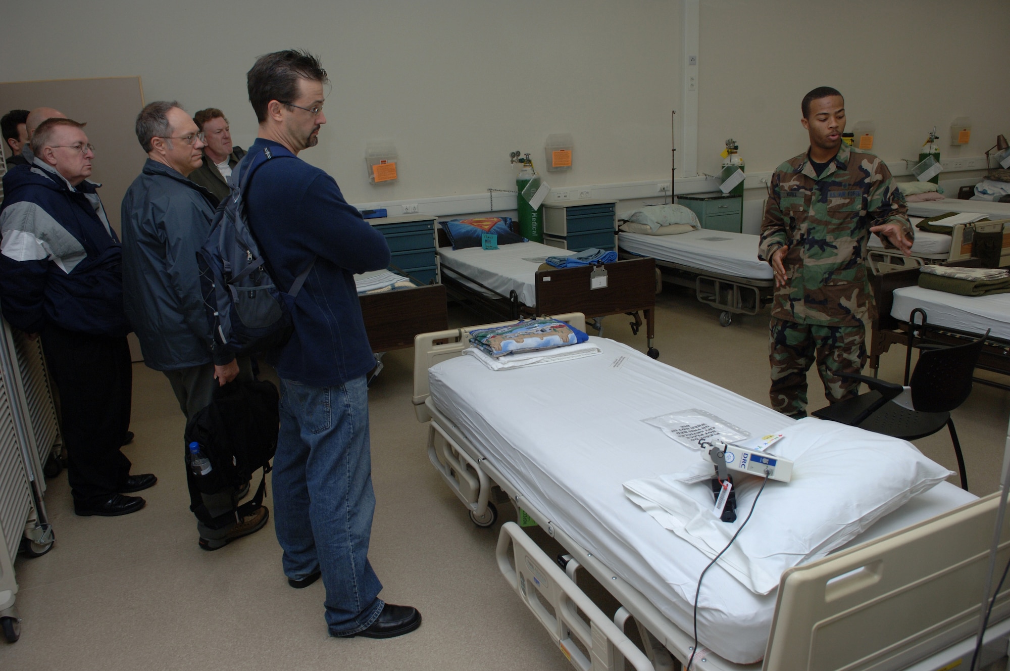 United States Air Force Airman 1st Class Jamal Verdell, 435th Contingency Aeromedical Staging Facility, gives cartoonist with the National Cartoonist Society a tour of the CASF, Ramstein, Air Base, Germany, Oct. 2, 2008. The cartoonists visited the CASF as part of a morale tour in cooperation with the USO. (U.S. Air Force photo by Airman 1st Class Tony R. Ritter) (Released)