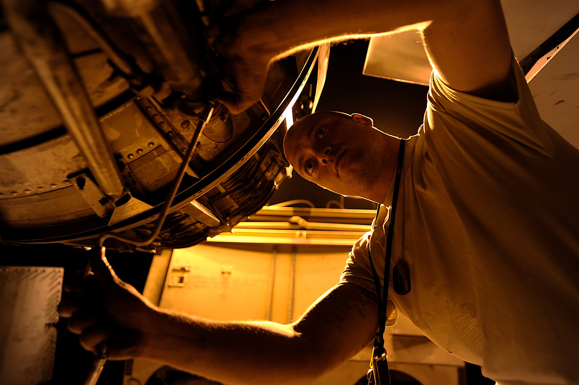 Staff Sgt. Nathan Gadbois tightens clamps around an actuator on an F-16 Fighting Falcon Oct. 6 at Joint Base Balad, Iraq. The actuators control the movement of the aircraft's exhaust nozzle. Gadbois, an aerospace propulsion journeyman with the 332nd Expeditionary Aircraft Maintenance Squadron, is deployed from Misawa Air Base, Japan. His hometown is Bryan, Texas. (U.S. Air Force photo/Airman 1st Class Jason Epley)