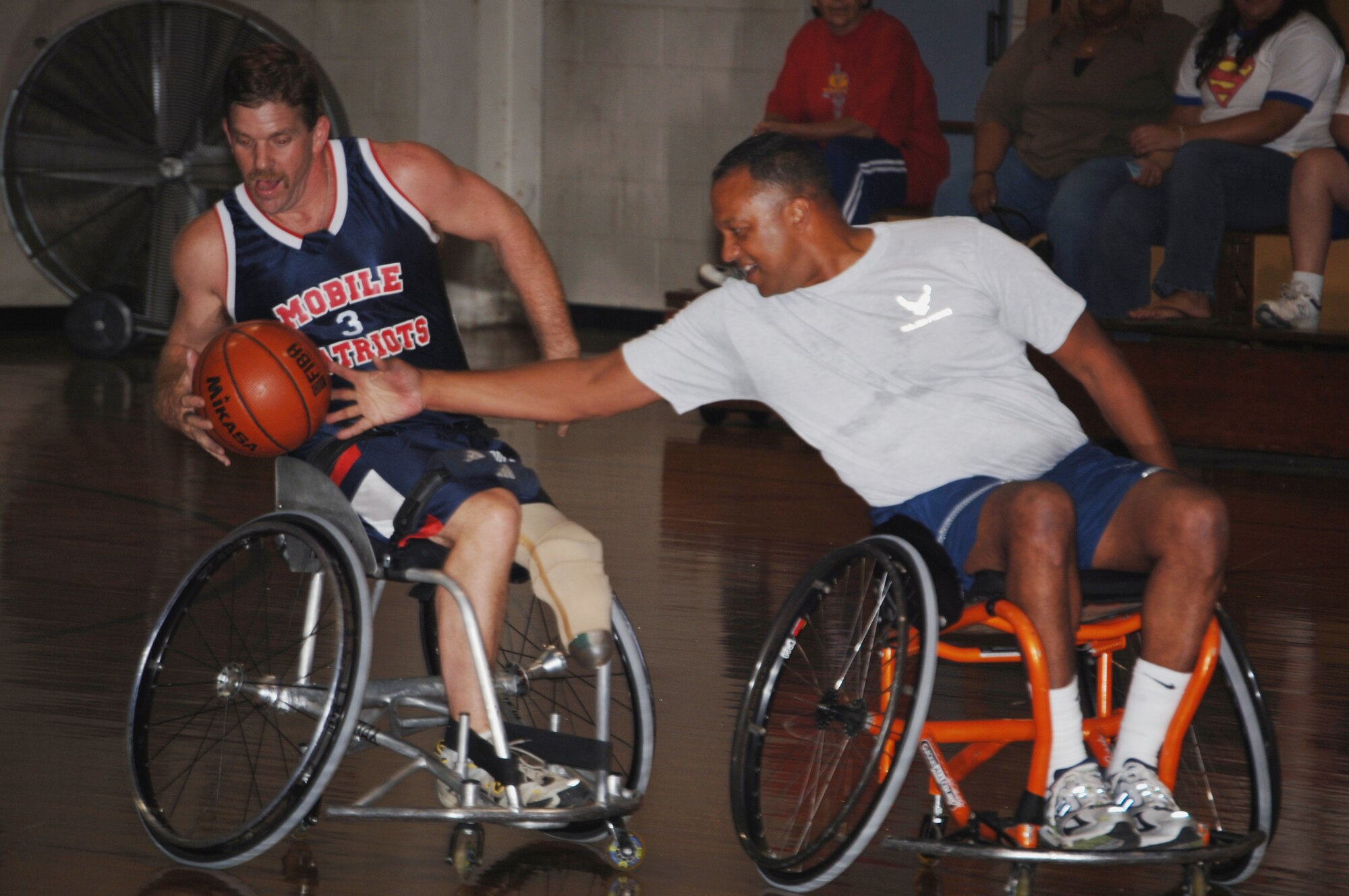 Lt. Col. Michael Hammond, 1st Special Operations Mission Support Group deputy commander, attempts a steal at the annual wheelchair basketball game Oct. 2 at the Fort Walton Beach Community Center. The competition, pittting Airmen from Hurlburt Field against the Mobile Patriots, a professional wheelchair basketball team, is held in recognition of National Disability Awareness Month. Despite spotting the Commandos 40 points, the Patriots won the game 58-46. (U.S. Air Force photo/ Senior Airman Emily Moore) 