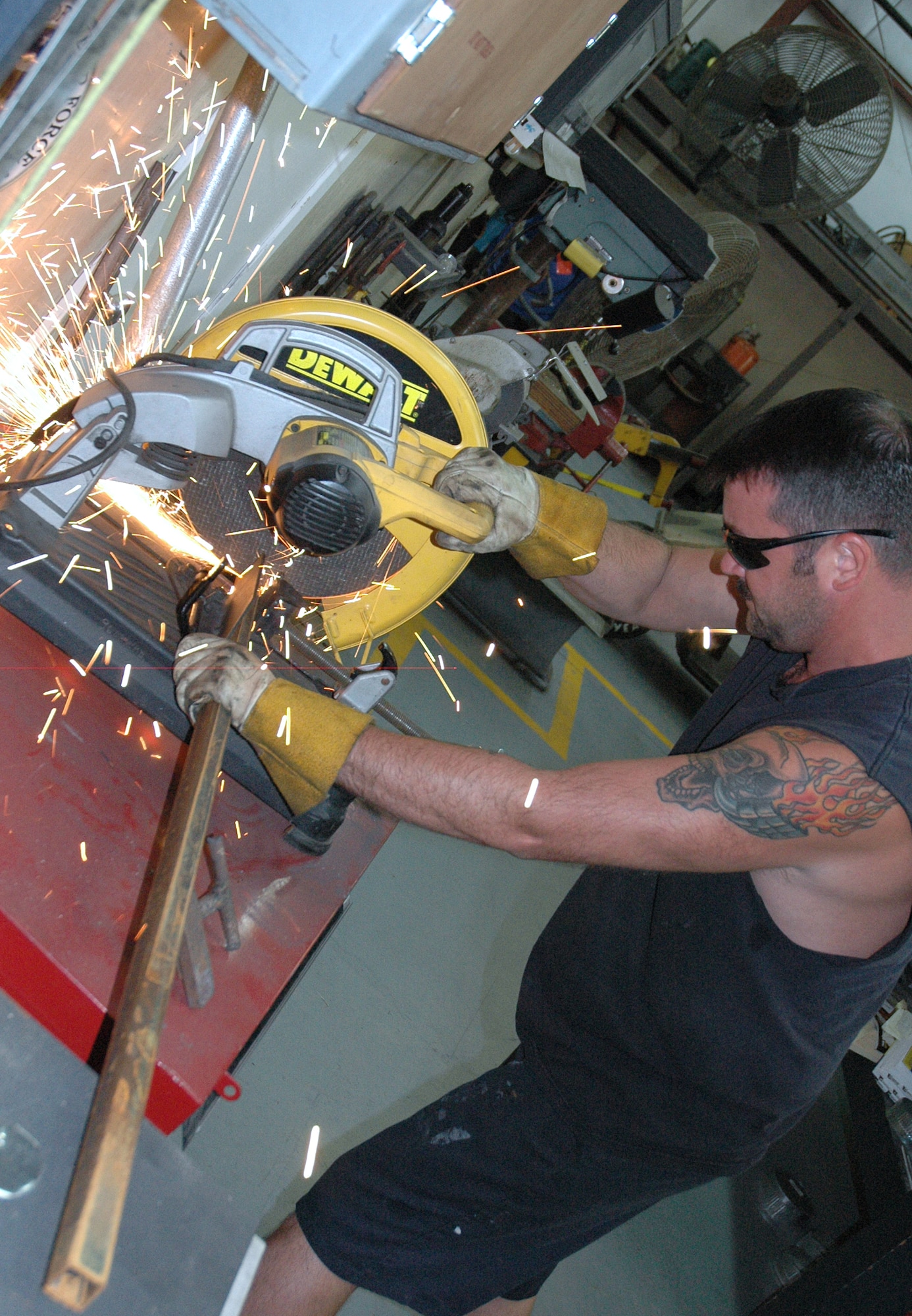 Master Sgt. Craig Sargent, 46th Maintenance Squadron, cuts a peice of metal down to size to replace a broken ladder on a static display at the Air Force Air Armament Museum as part of the Adopt-a-Plane initiaive. The initiative is a volunteer project aimed restoring and preserving Air Force history displayed at the museum. (U.S. Air Force photo/Staff Sgt. Stacia Zachary)