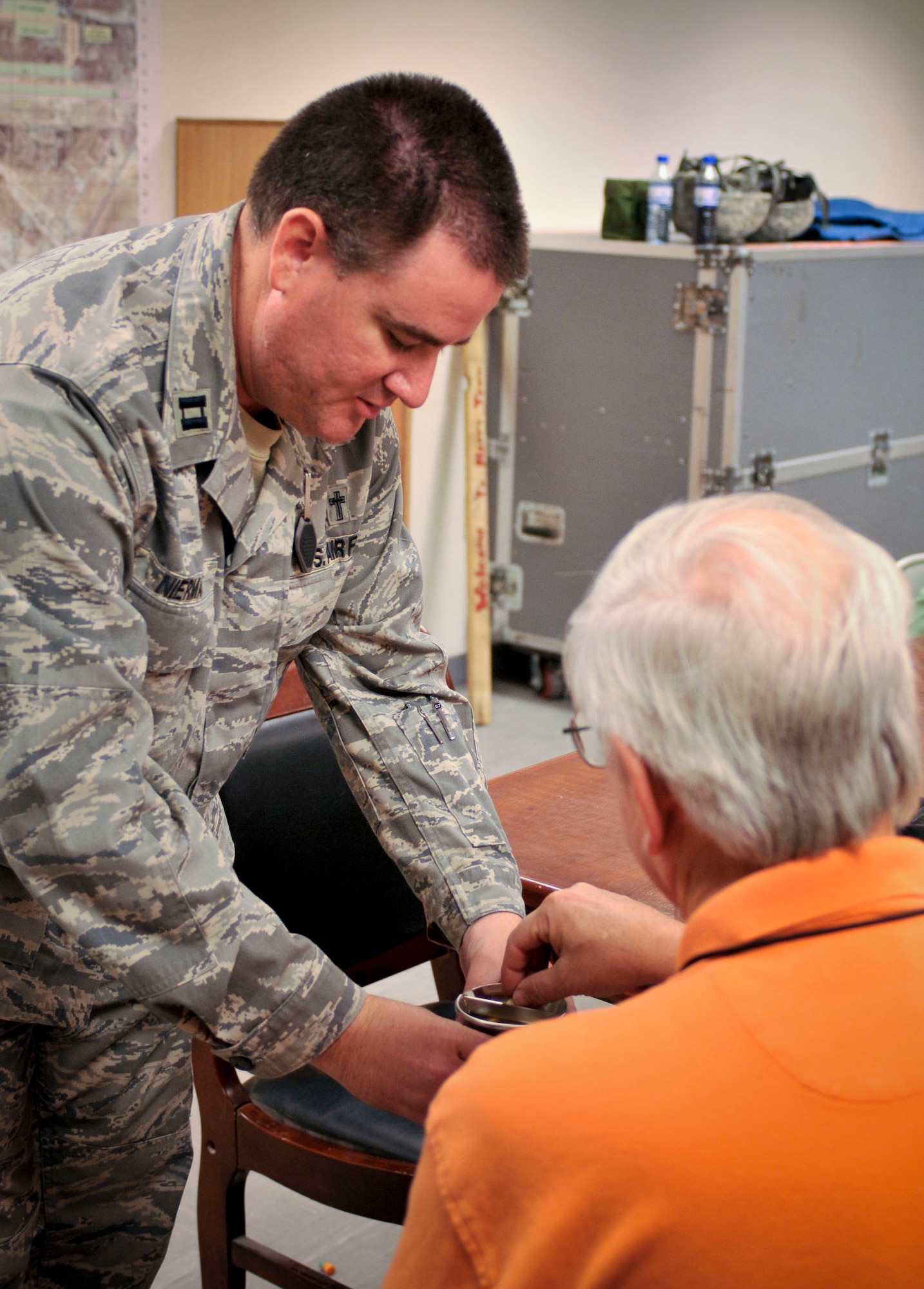 BAGRAM AIR FIELD, Afghanistan -- Ch. (Capt.) Brian Nierman, 455th Air Expeditionary Wing, administers Holy Communion here Oct. 5. Air Force chaplains work hard to meet the spiritual needs of the coalition forces deployed to Bagram Air Field. Chaplain Nierman is endorsed by the Christian Church (Disciples of Christ) and is deployed from the 18th Wing, Kadena Air Base, Japan. (U.S. Air Force photo by Staff Sgt. Samuel Morse/Released)
