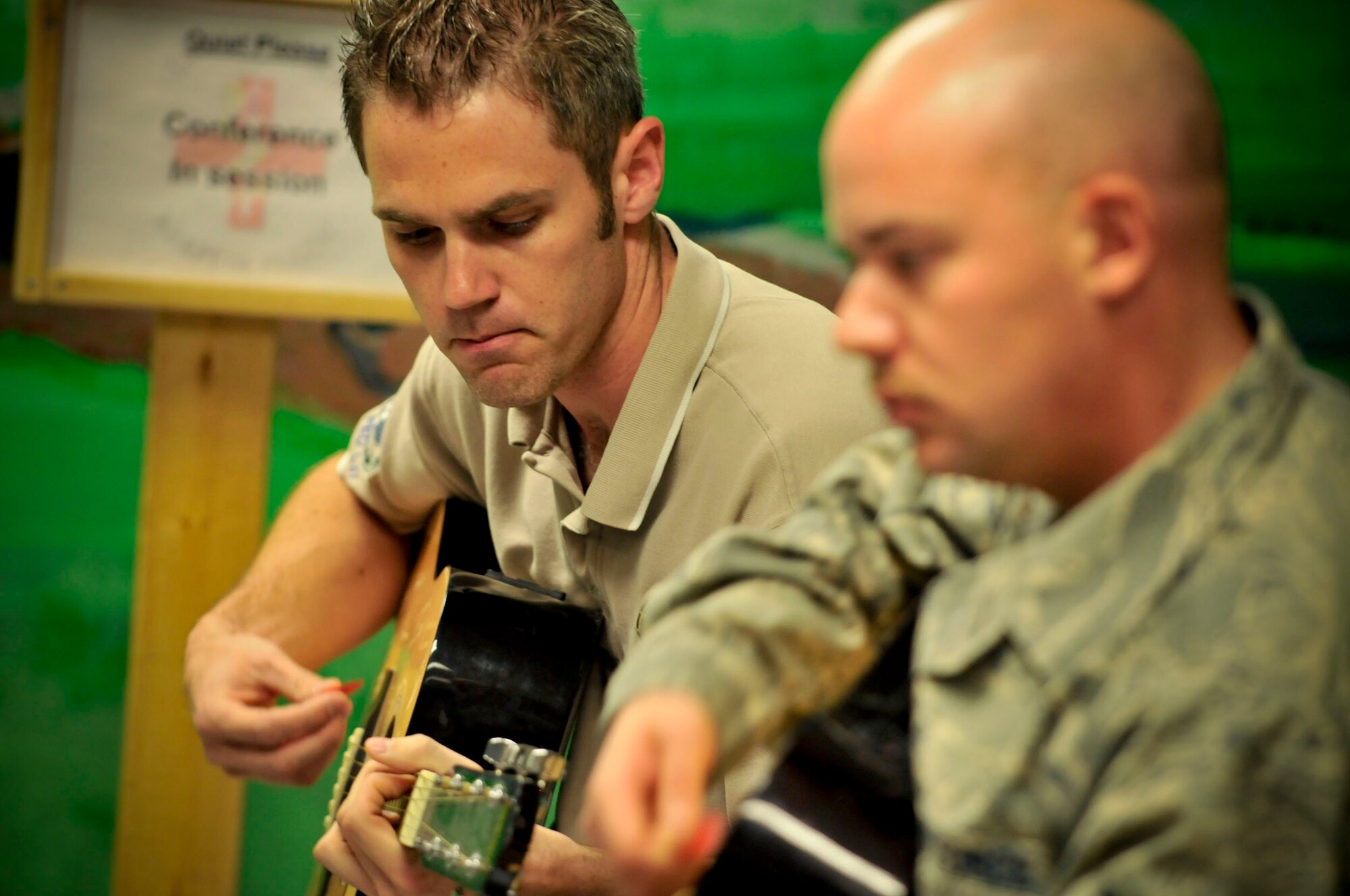 BAGRAM AIR FIELD, Afghanistan -- Craig Shelton plays guitar during a worship service here Oct. 5. The chaplains here at Bagram depend on volunteers like Shelton to lead the praise music for worship services. (U.S. Air Force photo by Staff Sgt. Samuel Morse/Released)