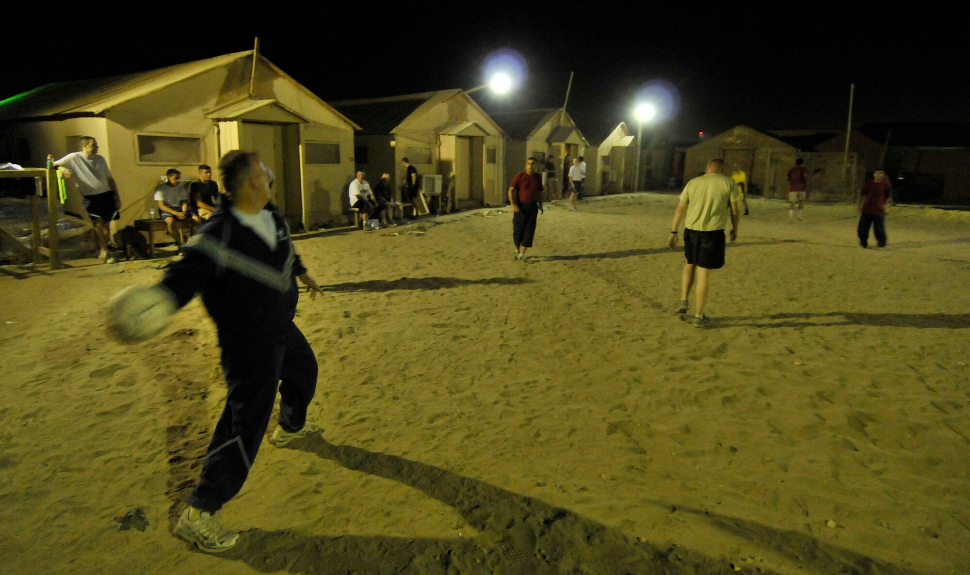 BAGRAM AIR FIELD, Afghanistan -- Ch. (Capt.) Andrew McIntosh, Task Force Medical, thows a soccer ball here Oct. 3. Chaplain McIntosh participates in the weekly multi-national soccer match, deepening his bond with the coalition forces that work with the Task Force Medical. Chaplain McIntosh is a Southern Baptist deployed from the 11th Wing, Bolling Air Force Base, Washington D.C. (U.S. Air Force photo by Staff Sgt. Samuel Morse/Released)