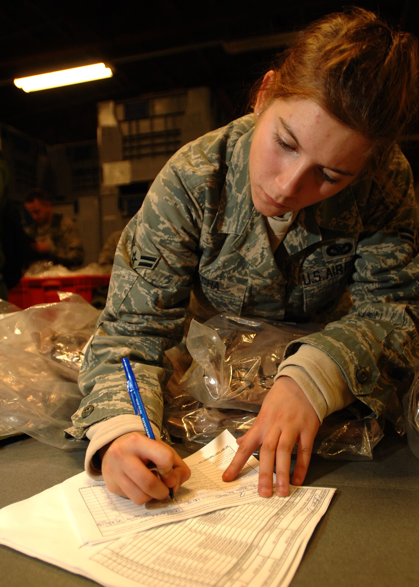 SPANGDAHLEM AIR BASE, Germany -- Airman 1st Class Alexandra Jecha, 52nd Security Forces Squadron, completes a hand receipt for equipment issued during the Personnel Deployment Function portion of the Phase I exercise at Spangdahlem Air Base on Sept. 29, 2008. Spangdahlem AB conducted a base-wide exercise to test the readiness of personnel for deployment. (U.S. Air Force photo by Airman 1st Class Nathanael Callon)