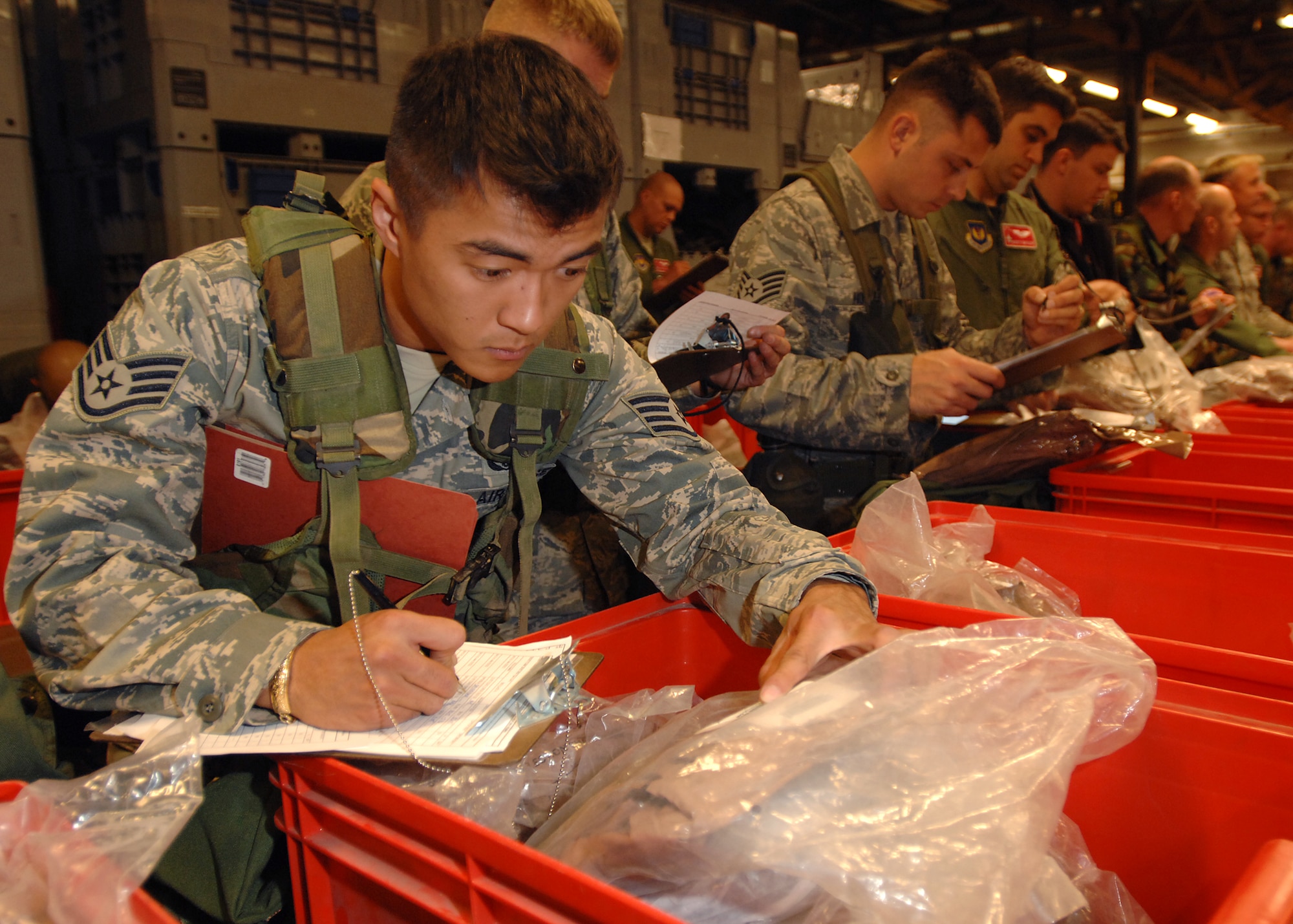 SPANGDAHLEM AIR BASE, Germany -- Staff Sgt. Hoa Mai, 52nd Civil Engineer Squadron, completes a hand receipt for equipment issued during the Personnel Deployment Function portion of the Phase I exercise at Spangdahlem Air Base on Sept. 29, 2008. Spangdahlem AB conducted a base-wide exercise to test the readiness of personnel for deployment. (U.S. Air Force photo by Airman 1st Class Nathanael Callon)