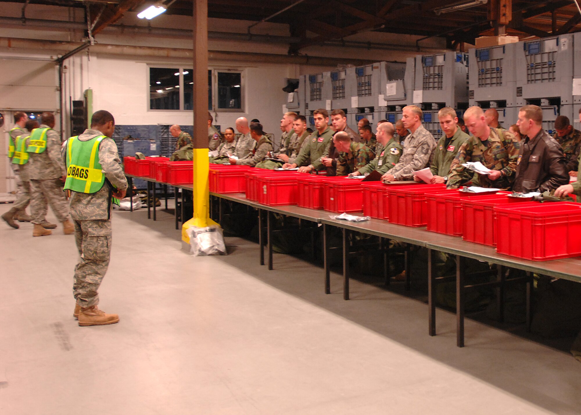 SPANGDAHLEM AIR BASE, Germany -- Members of the 52nd Logistics Readiness Squadron brief deployers about mobility bags during the Personnel Deployment Function portion of the Phase I exercise at Spangdahlem Air Base on Sept. 29, 2008. Spangdahlem AB conducted a base-wide exercise to test the readiness of personnel for deployment. (U.S. Air Force photo by Airman 1st Class Nathanael Callon)