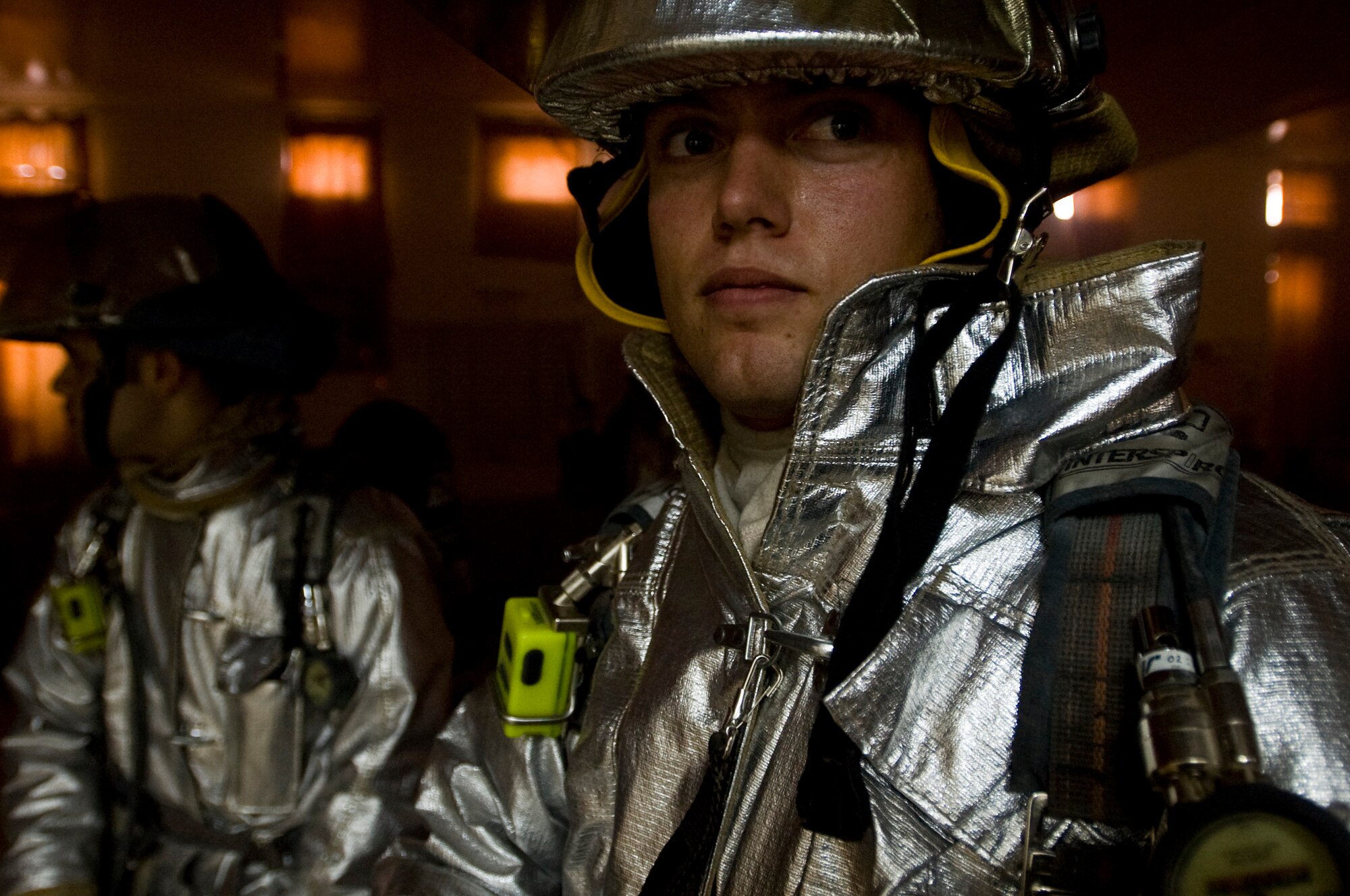 ALI BASE, Iraq -- Senior Airman Nathan Sole, 407th Expeditionary Civil Engineer Squadron fire fighter, scans a room for fire hazards Oct. 3, 2008. The 407th ECES fire department contains Airmen from several different bases. It held a structural drill to evaluate how the unit would respond to a fire alert. Sole is deployed from 133rd Airlift Wing, Minnesota Air National Guard. (U.S. Air Force photo/Airman 1st Class Christopher Griffin)