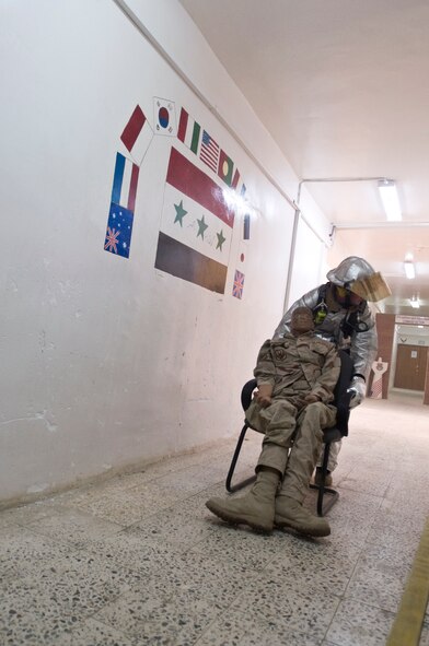 ALI BASE, Iraq -- Tech. Sgt. Andrew Vorlicek, 407th Expeditionary Civil Engineer Squadron fire fighter, drags a dummy away from a smoke-filled room Oct. 3, 2008. The 407th ECES fire fighters held a structural drill at the passenger terminal here evaluating from dispatch to the actual response itself. Vorlicek is deployed from 133rd Airlift Wing, Minnesota Air National Guard. (U.S. Air Force photo/Airman 1st Class Christopher Griffin)