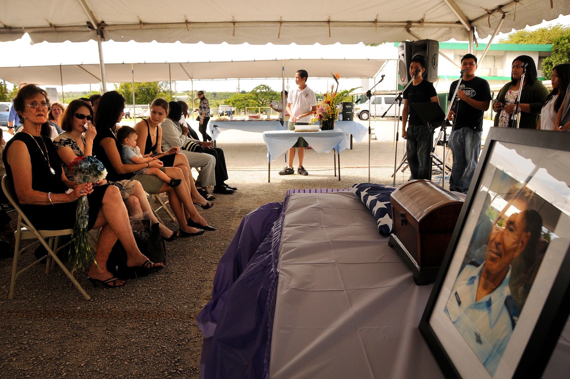 ANDERSEN AIR FORCE BASE, Guam - Ann Merritt, wife of retired Air Force Col. Walter "Tony" Merritt, looks on with family during the memorial service at the John F. Kennedy High School in Tammuning, Guam, Oct. 4, 2008.  Colonel Merritt served a total of 63 years in uniform. (U.S. Air Force photo by Airman 1st Class Courtney Witt)