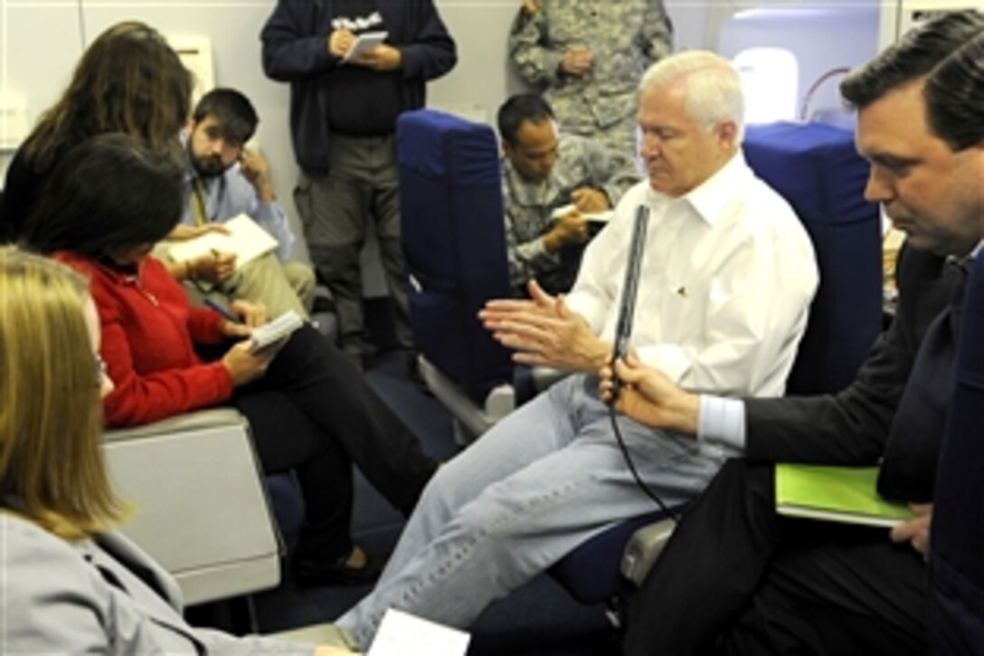 U.S. Defense Secretary Robert M. Gates briefs the press onboard a military aircraft while flying over the Atlantic Ocean, Oct. 6, 2008. Gates is en route to a southeast Europe defense ministerial conference in Macedonia and a NATO meeting in Hungary. 