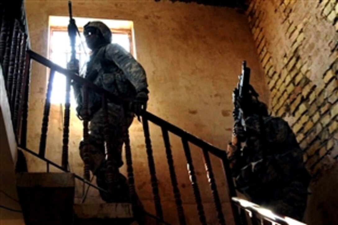 U.S. Army soldiers ascend stairs to clear a roof as they search the neighborhood for a sniper suspect in the Sadr City district of Baghdad, Iraq, Sept. 30, 2008. The soldiers are assigned to 1st Battalion, 6th Infantry Regiment.