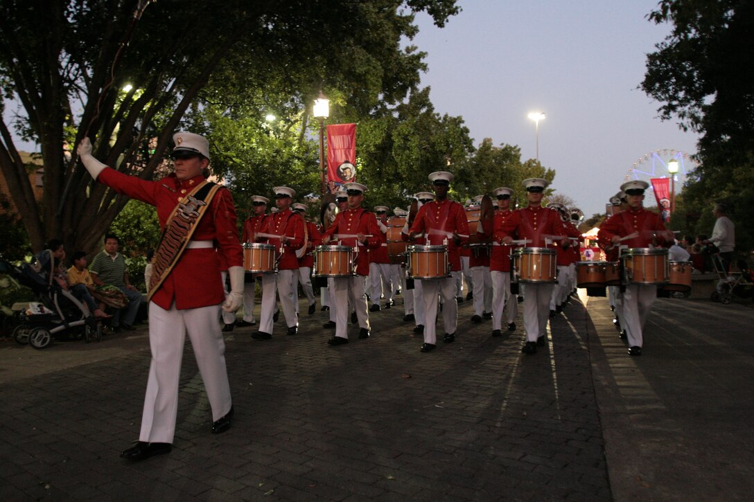 Staff Sgt. Alexandra Perkins leads the U.S. Marine Drum and Bugle Corps from Marine Barracks Washington, D.C., during the "Starlight Parade" at the State Fair of Texas in Dallas, Oct. 7.  Perkins is the first female to lead the Drum and Bugle Corps from a Drum Major position.
