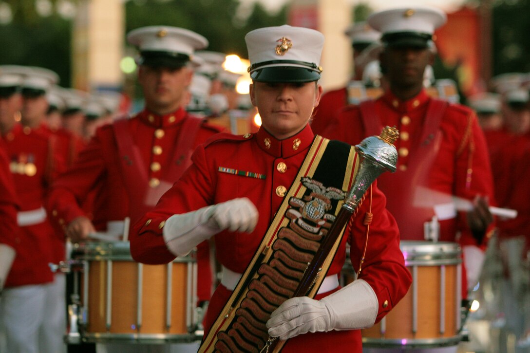 Staff Sgt. Alexandra Perkins leads the U.S. Marine Drum and Bugle Corps from Marine Barracks Washington, D.C., during the "Starlight Parade" at the State Fair of Texas in Dallas, Oct. 7.  Perkins is the first female to lead the Drum and Bugle Corps from a Drum Major position.