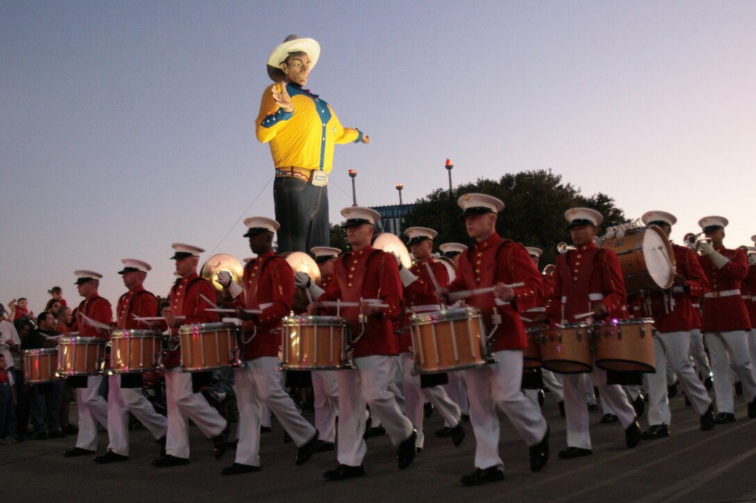 The drum line of the U.S. Marine Drum and Bugle Corps from Marine Barracks Washington, D.C., marches past "Big Tex" at the State Fair of Texas in Dallas, Oct. 7.  The Drum and Bugle Corps has performed at the state fair for more than 40 consecutive years.