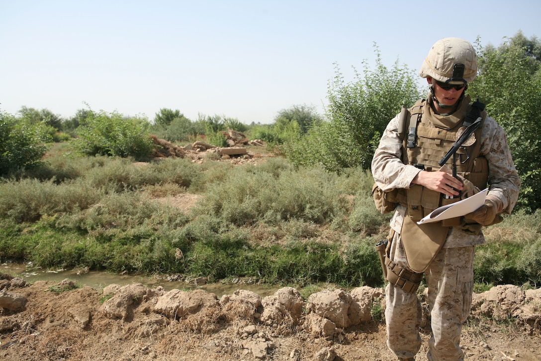 1st Lt. David B. Gilliland, a 24-year-old civil affairs team leader with Civil Affairs Team 3, 2nd Battalion, 11th Marine Regiment, Regimental Combat Team 1, reads over project plans for an irrigation canal being built in the Sophia area of Ramadi, Iraq, Oct. 8. Gilliland, a Florence, Ky. native, and his team works to facilitate engineer projects in Ramadi. (Released)(Official U.S. Marine Corps photo by Cpl. Chris T. Mann)