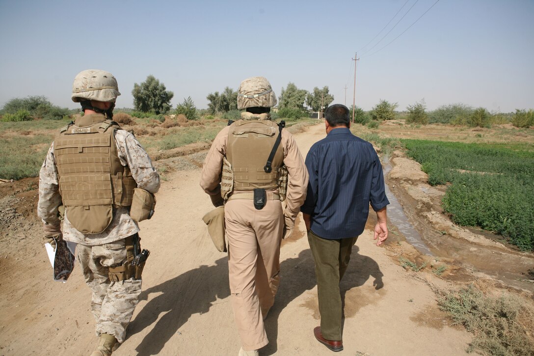 Marines with Civil Affairs Team 3, 2nd Battalion, 11th Marine Regiment, Regimental Combat Team 1, and an Iraqi contractor observe an irrigation canal being built in Sophia area of Ramadi, Iraq, Oct. 8. (Released)(Official U.S. Marine Corps photo by Cpl. Chris T. Mann)