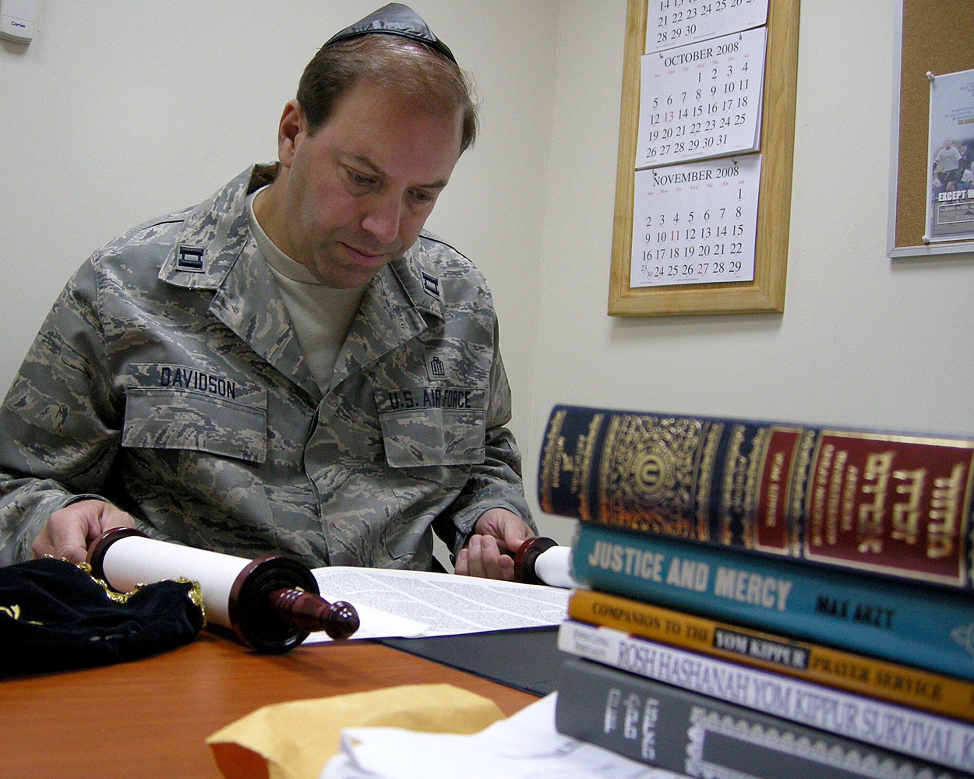 SOUTHWEST ASIA -- Rabbi (Capt.) Gary Davidson reviews the Torah at the 380th Air Expeditionary Wing Chapel here Monday. Rabbi Davidson deployed for one month to the Area of Operations to perform religious services for deployed Jewish members. He will be dividing his time spent away from the U.S. Air Force Academy at three different locations during some of the most important Jewish holidays of the year. (U.S. Air Force photo by Tech. Sgt. Denise Johnson)(released)