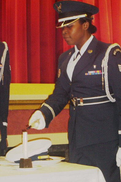 Staff Sgt. Hilda Agyemang lights a candle during the POW/MIA Table Ceremony to symbolize vigilance for those still missing. (U.S. Air Force photo by Will Alexander, 452 AMW)