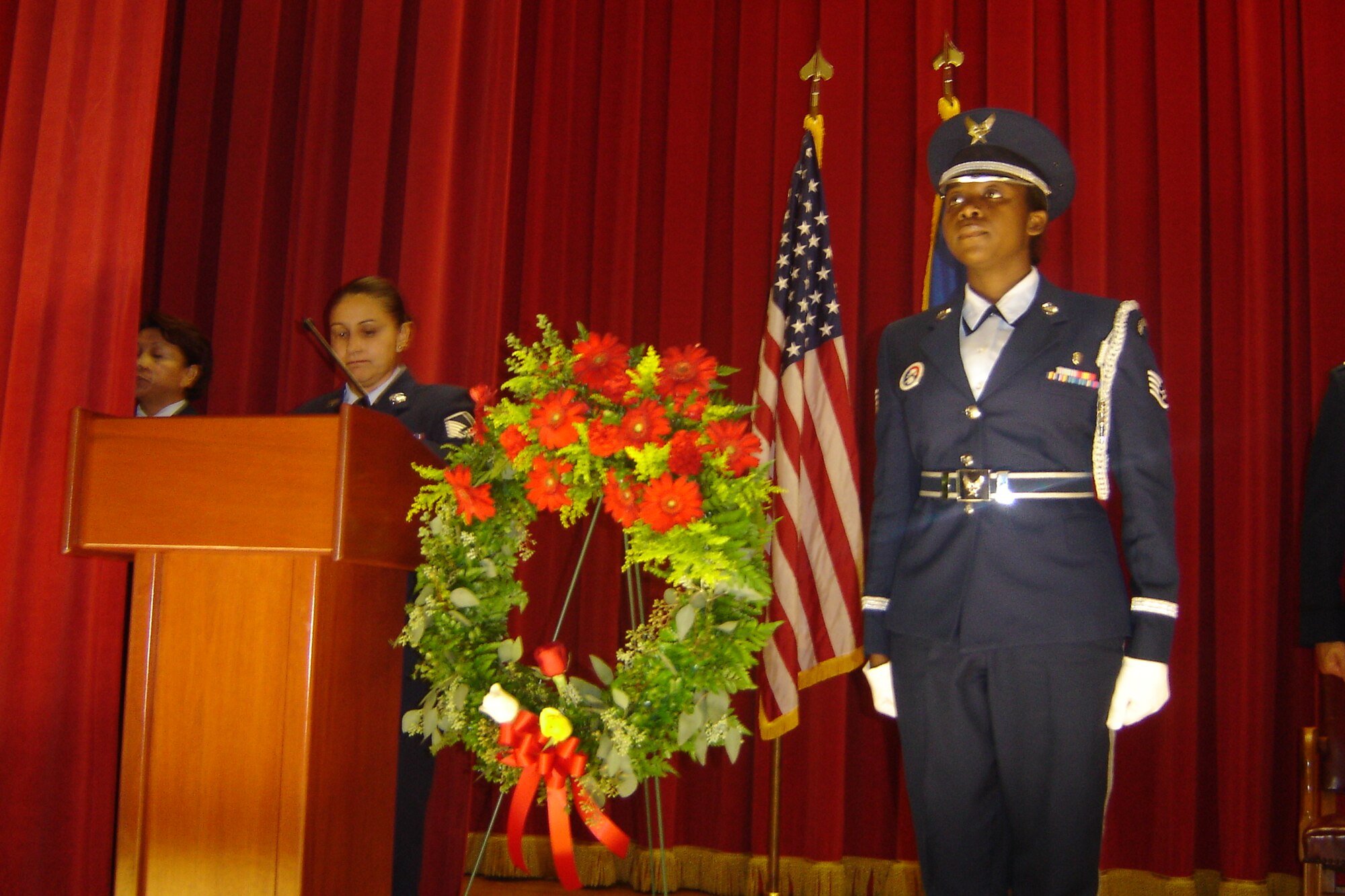 Wreath bearer Staff Sgt. Hilda Agyemang stands at attention after placing a wreath. The red roses are for those who gave their lives; the white, for those who return; the yellow, for those still missing; and the red ribbon is for love of country and comrades who were willing to give all for freedom. (U.S. Air Force photo by Will Alexander, 452 AMW)