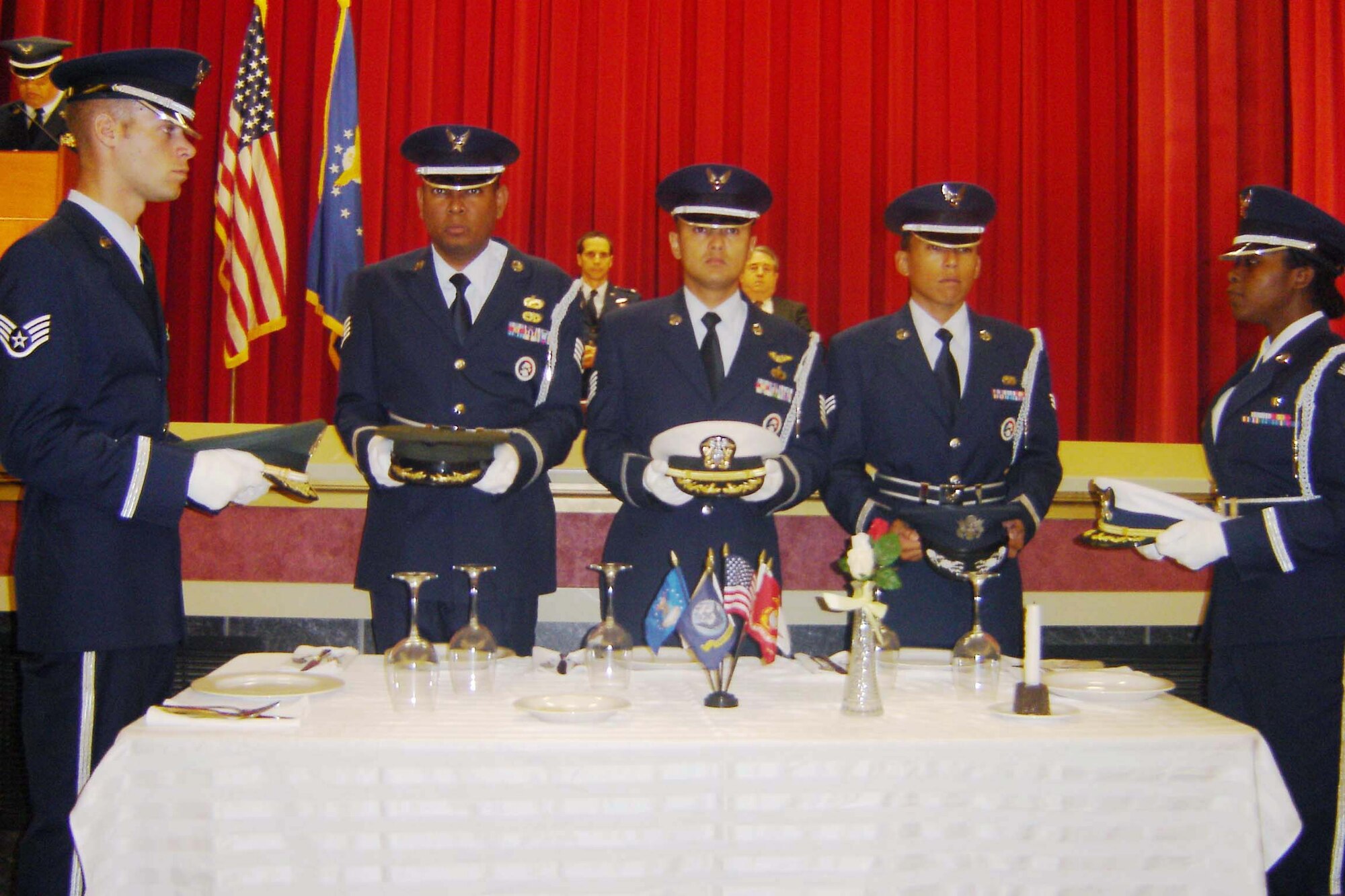 Members of the Honor Guard hold covers from each of the five services during the POW/MIA Table Ceremony, Sept. 19. The covers represent the missing in action from past wars in the Navy, Air Force, Marine Corps, Army and the Coast Guard. Pictured are (left to right): Staff Sgt John Ahrens, Staff Sgt. Keith Lawson, Tech. Sgt. Neil
Ballecer, SrA Terrence Mananes and Staff Sgt. Hilda Agyemang. Master Sgt. Robert Carreon narrated the ceremony. (U.S. Air Force photo by Will Alexander, 452 AMW)